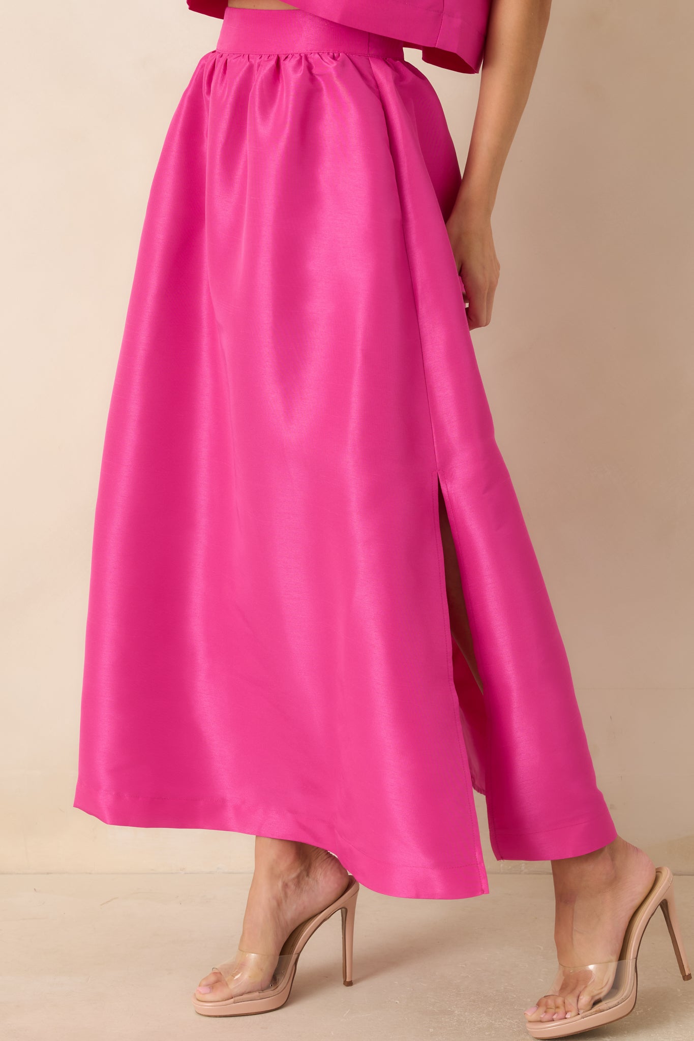 Close view of the fuchsia skirt highlighting the gathered waistband and structured woven texture.