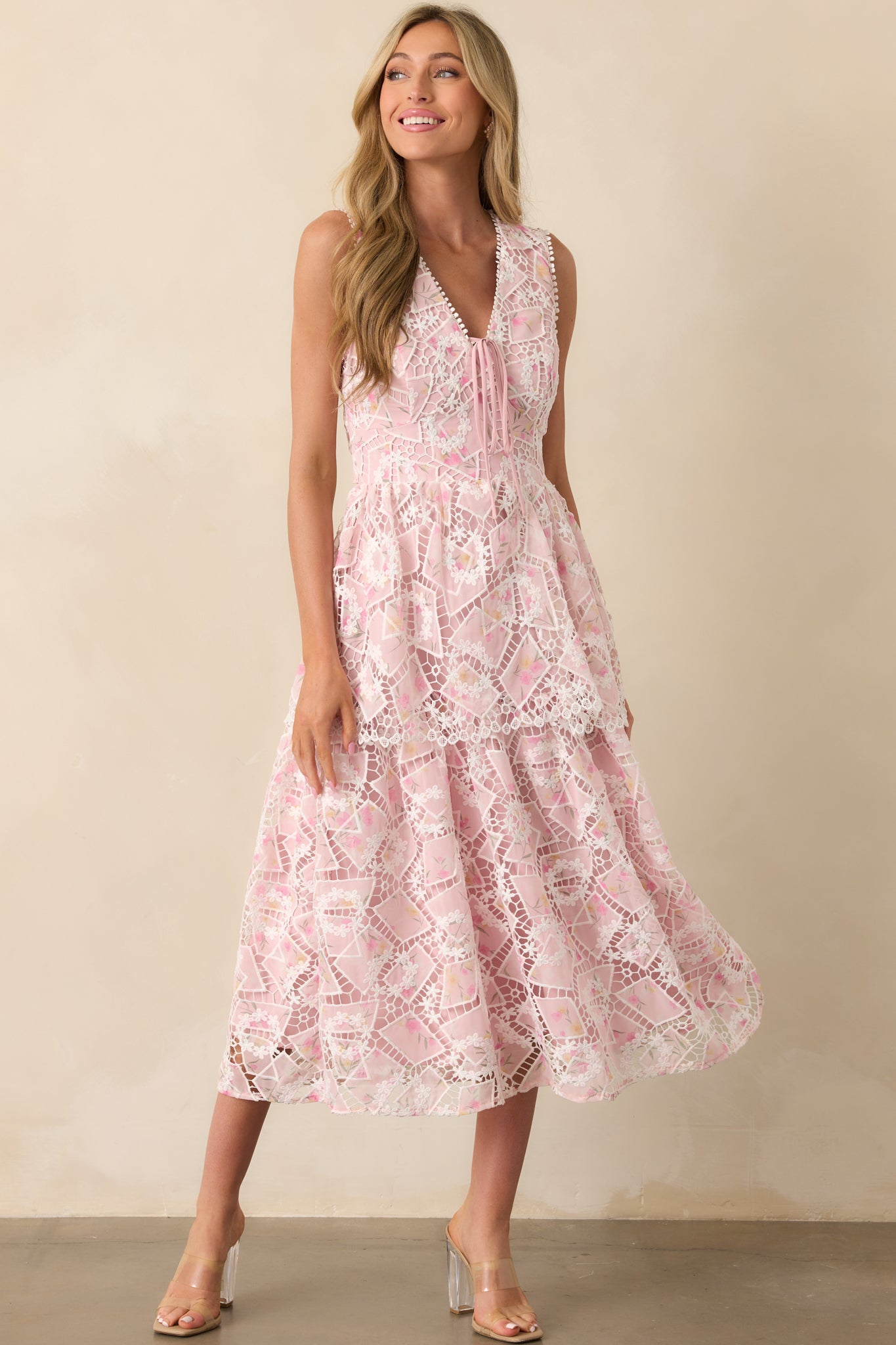 Full body front angle emphasizing the tiered skirt and semi-sheer effect of the floral tulle over the light pink lining.