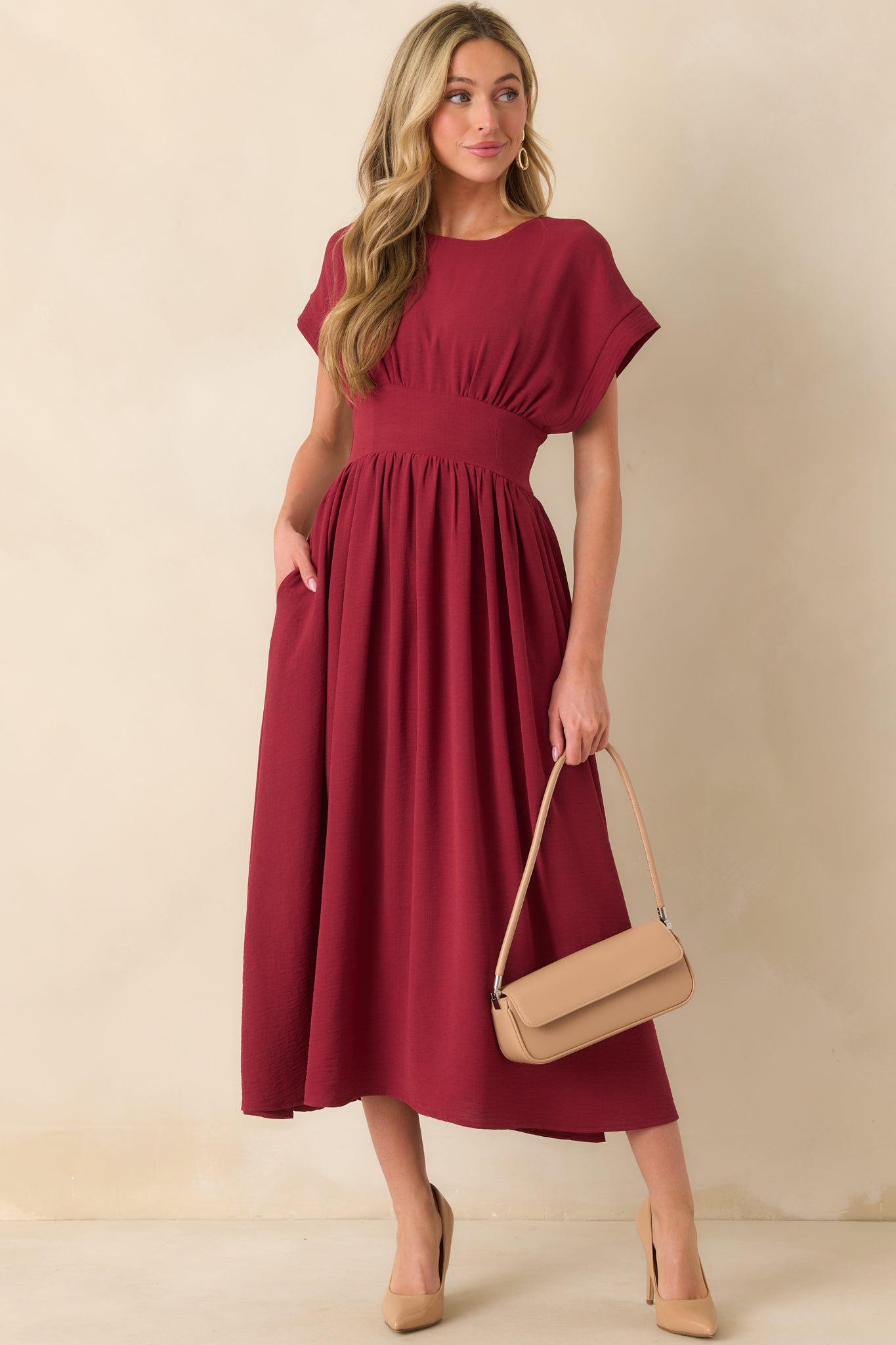 Full body front view of the burgundy dress showcasing the round neckline and cap sleeves.