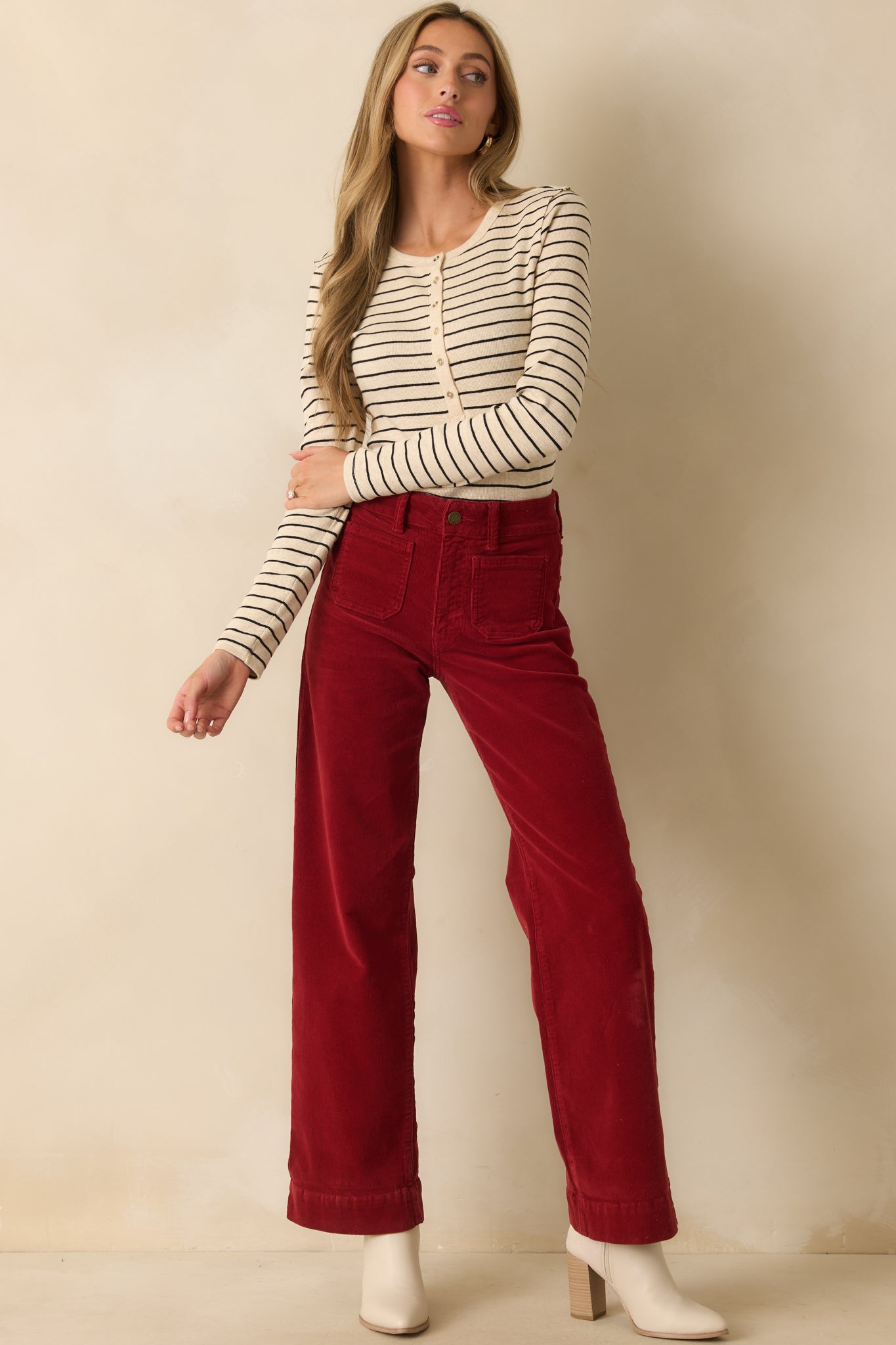 Full body front view of deep red corduroy pants with a high-rise waist, wide leg silhouette, and belt loops.