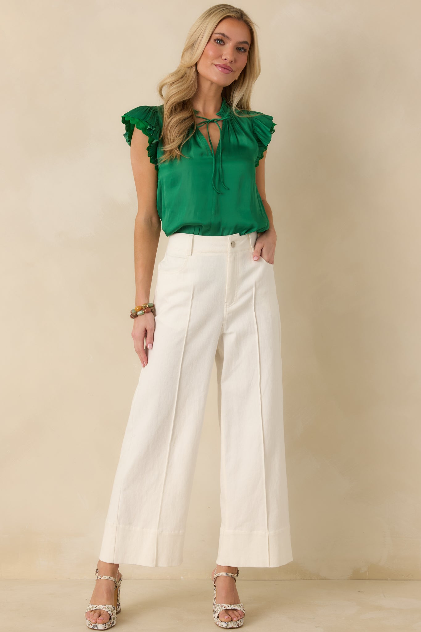 Full body front view of the green blouse highlighting the relaxed fit and delicate lace-trimmed sleeves.
