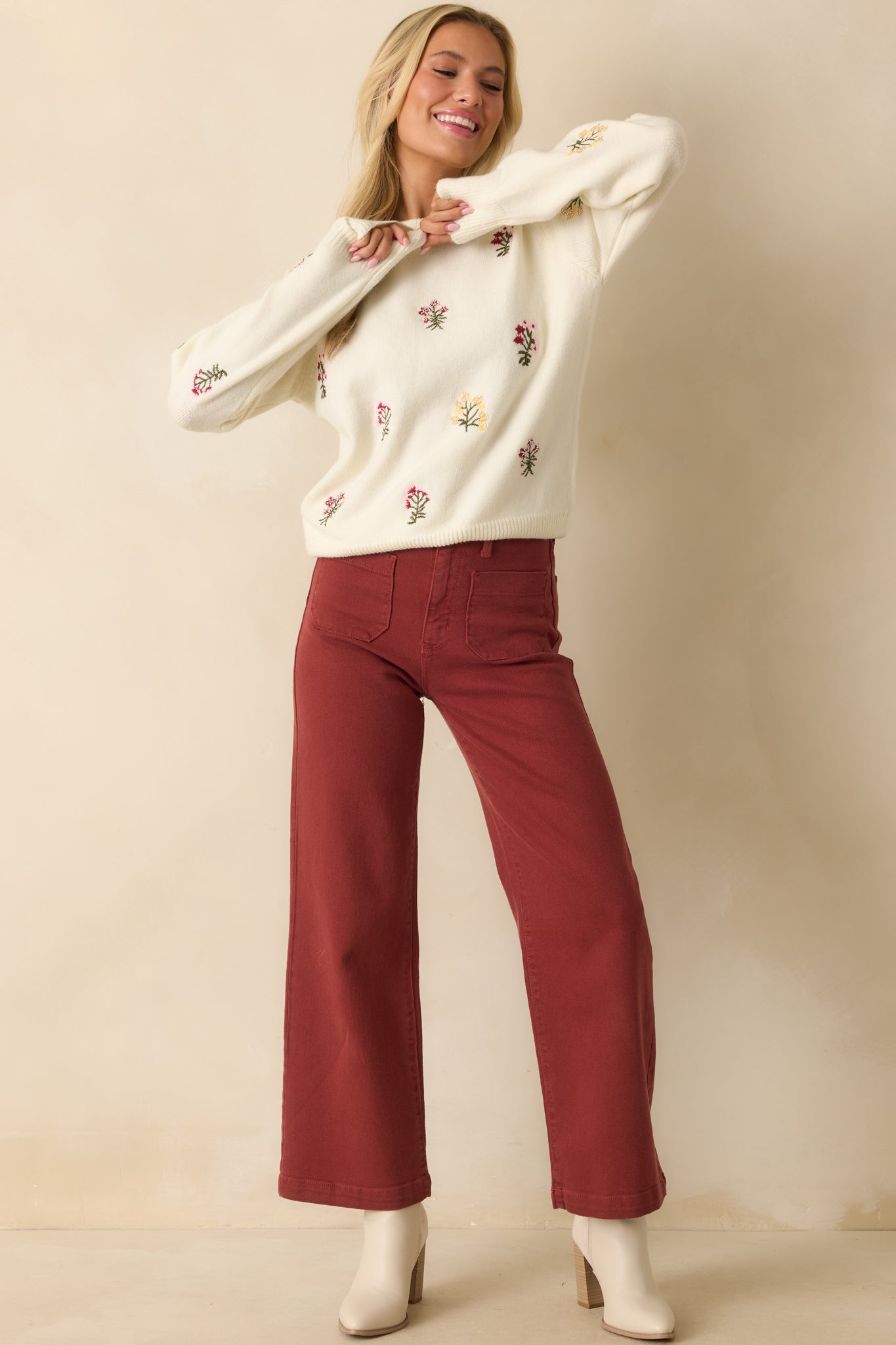 Full body front view of an ivory sweater with multicolor floral embroidery, crew neckline, and long sleeves.