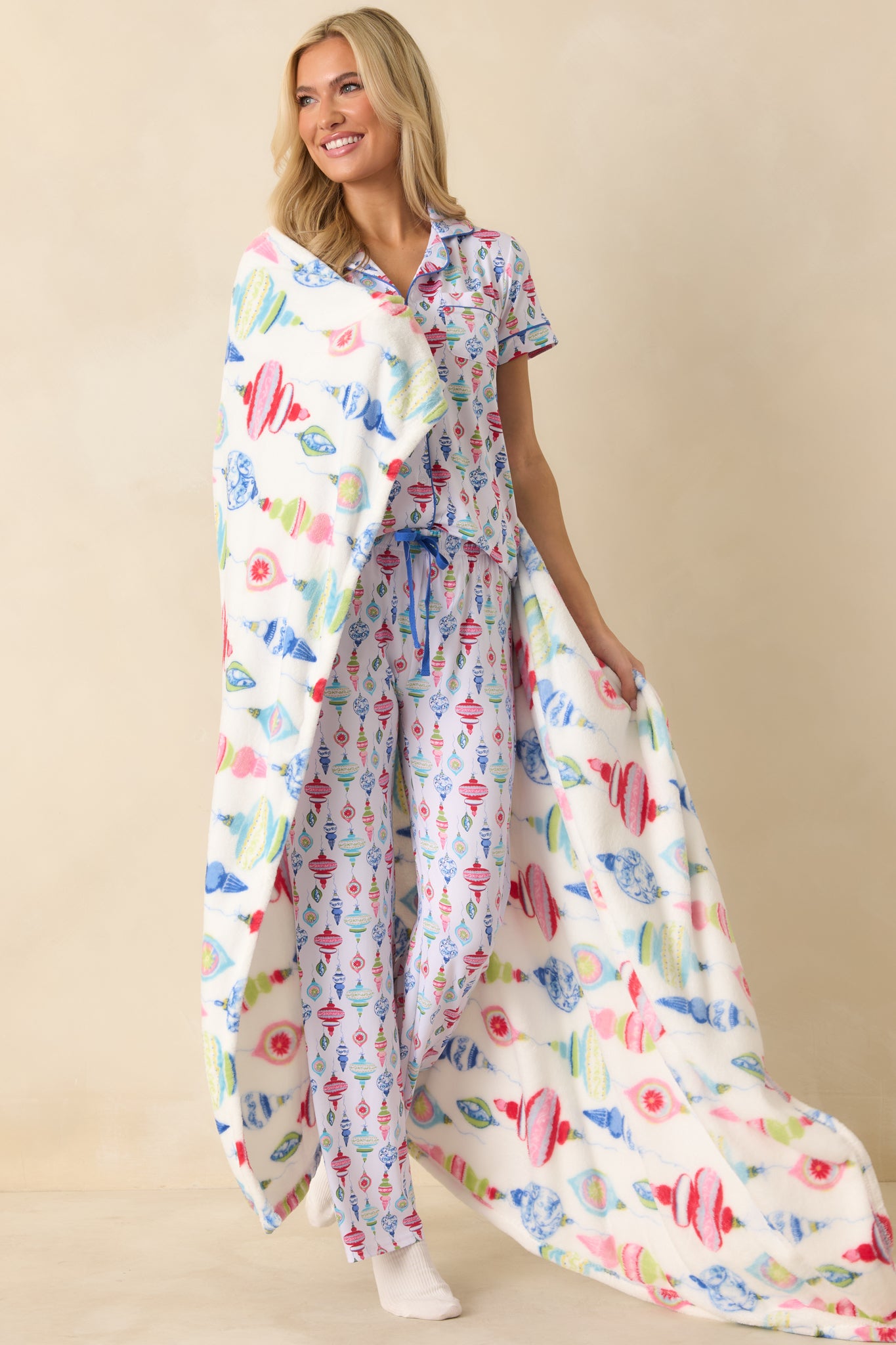 Full-body image highlighting the green and pink ornaments and woven details of the blanket.