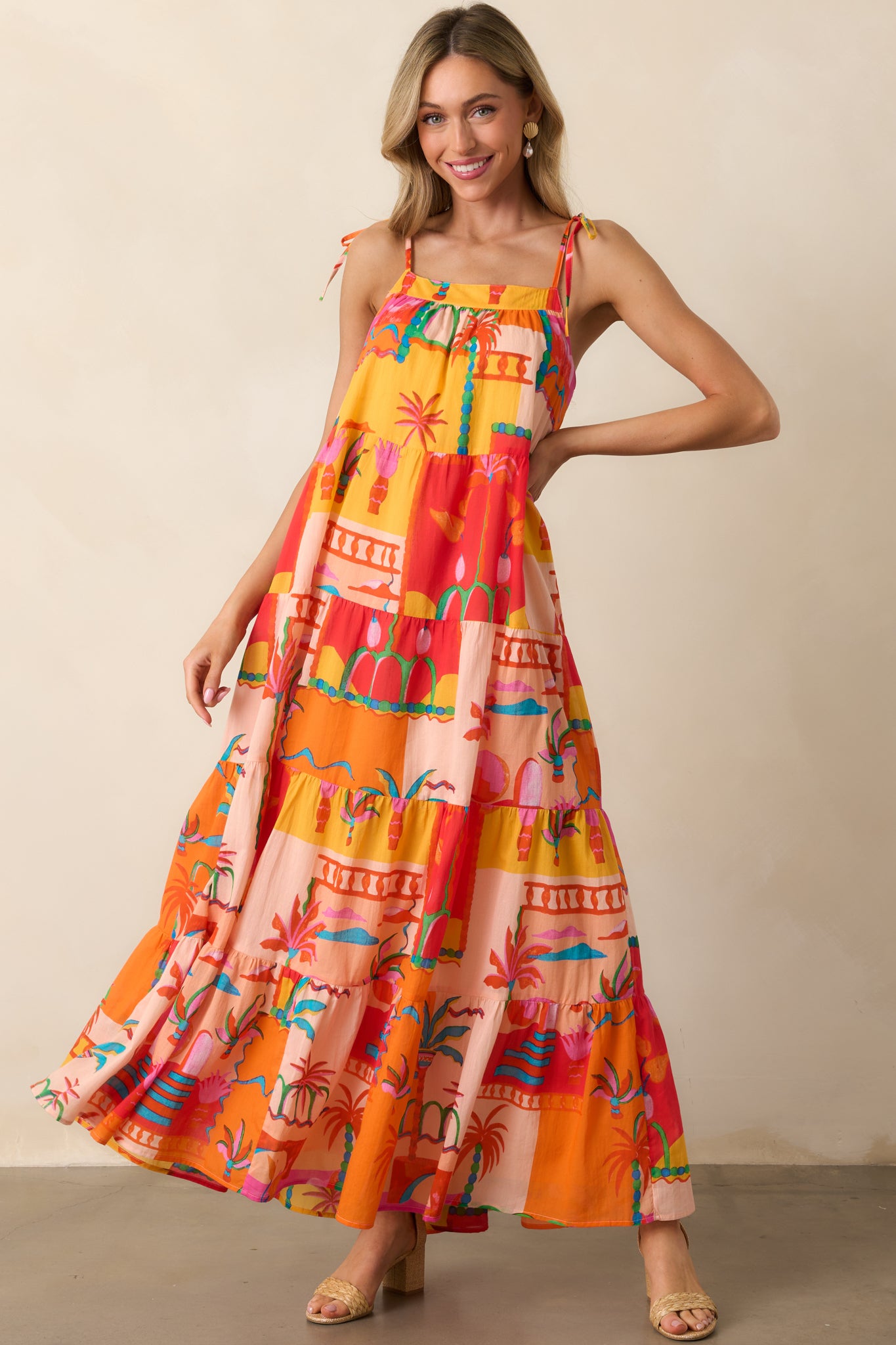 Full body front-facing photo emphasizing the lightweight drape and oversized shape of the tiered orange dress.