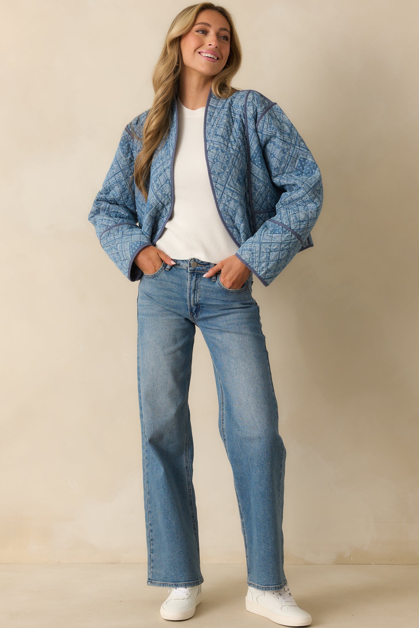 Full body shot of the quilted jacket, emphasizing the shawl lapels and long sleeves.