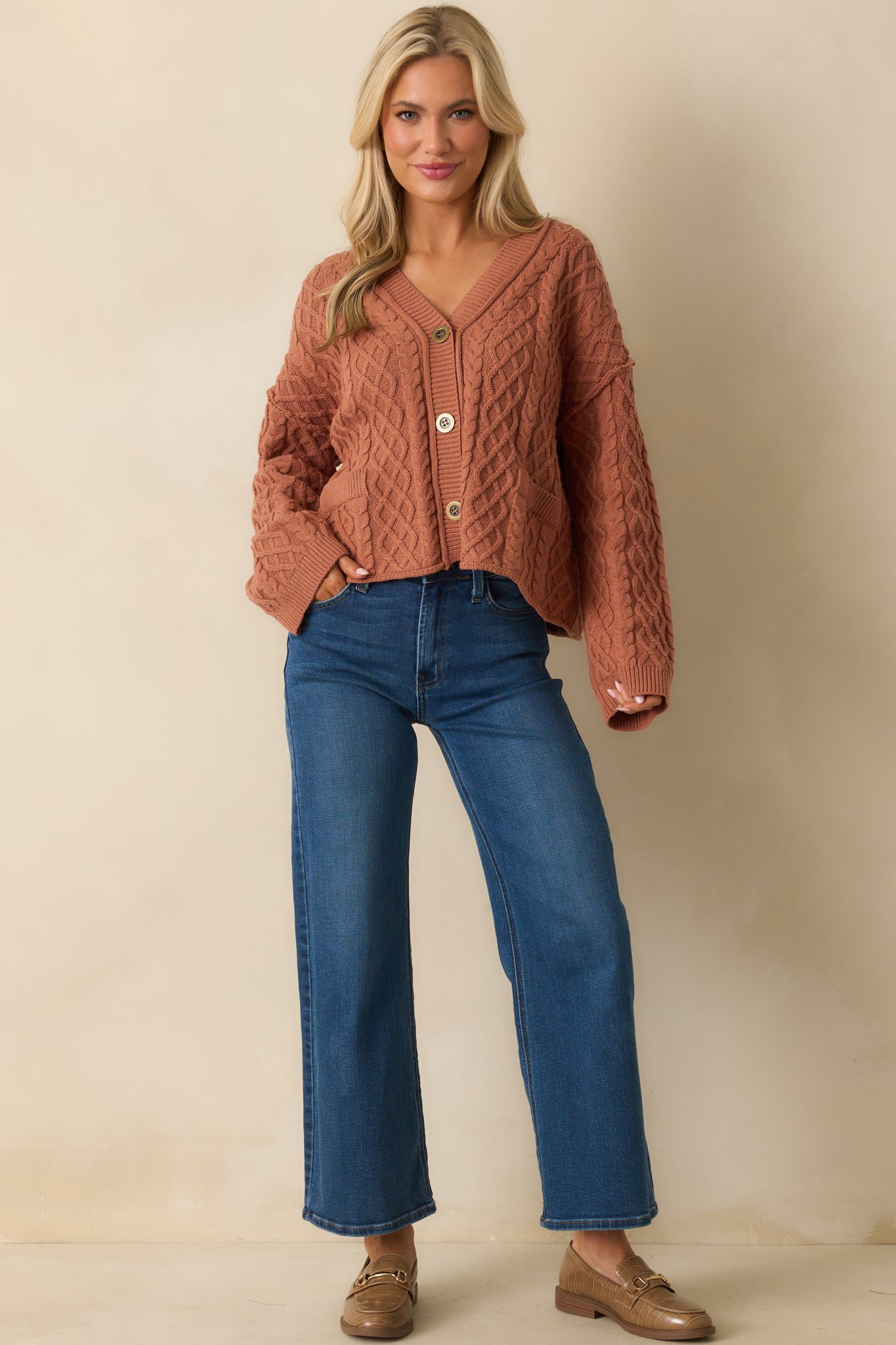 A full body shot highlighting the relaxed fit and long sleeves with ribbed cuffs.