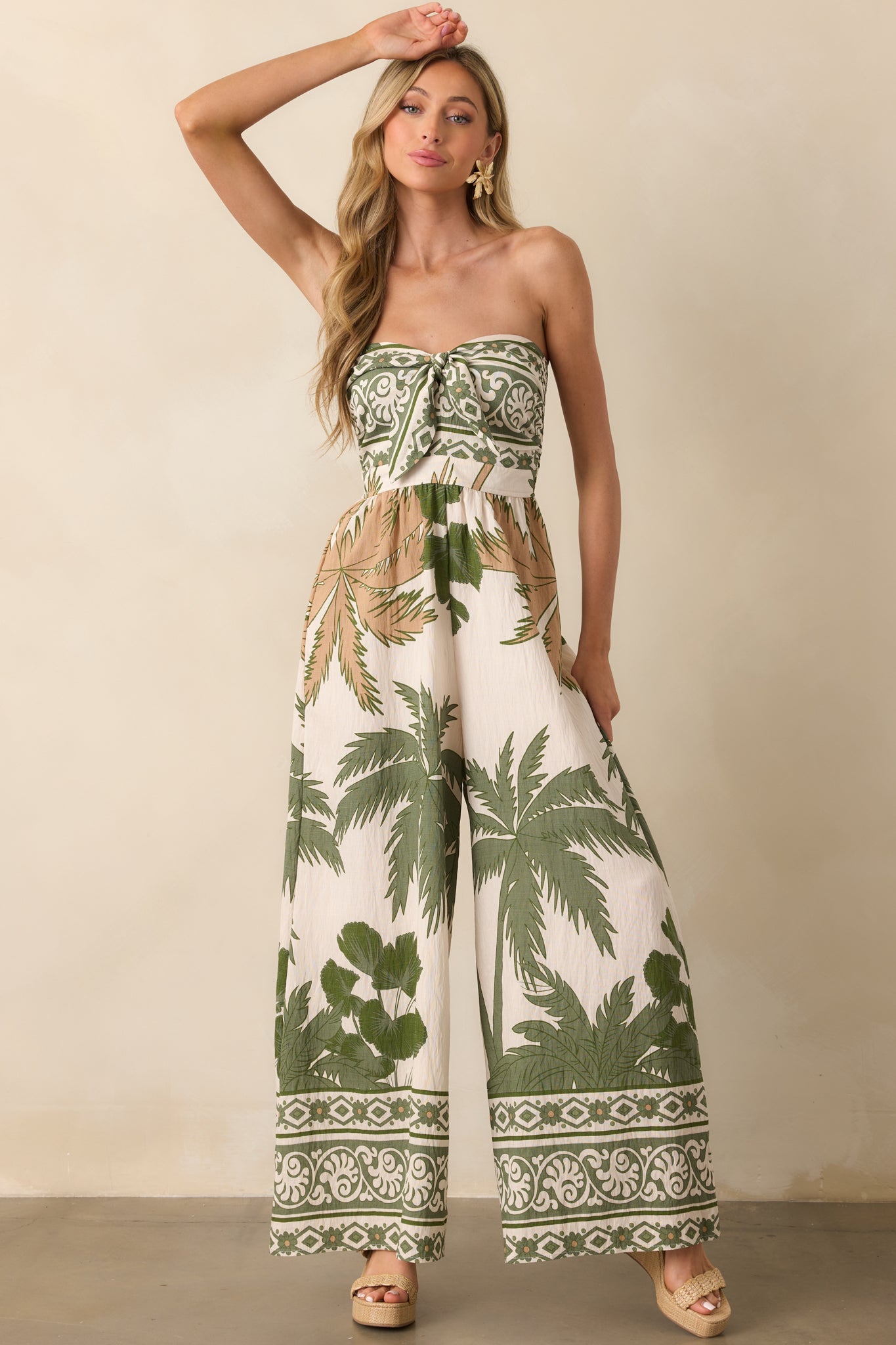 Full body standing pose with slight step forward, showcasing the drape of the fabric and knot front feature.