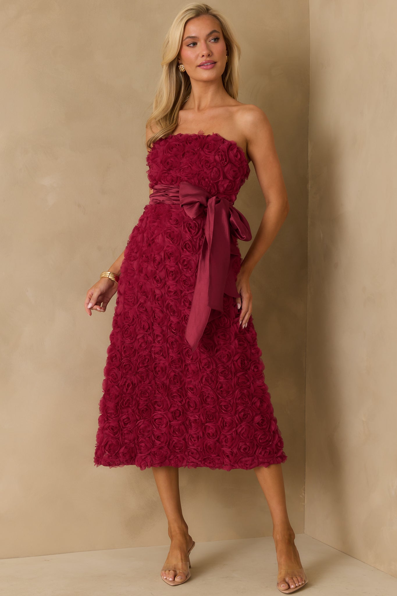 Full body photo emphasizing the strapless neckline and midi length hem.