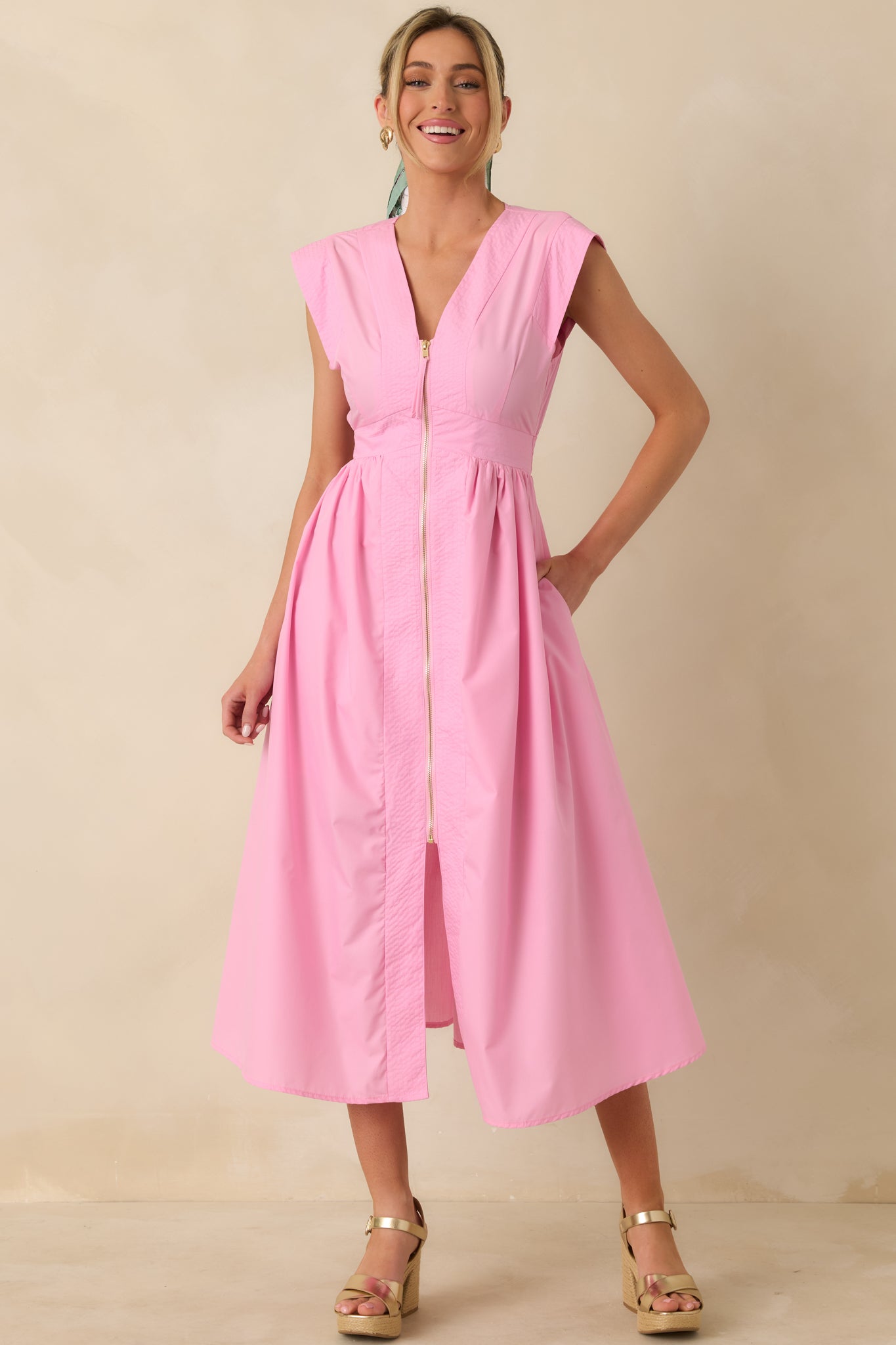 Straight-on full body view emphasizing the defined waist seam and gentle gathering through the skirt beneath the zip-front bodice.
