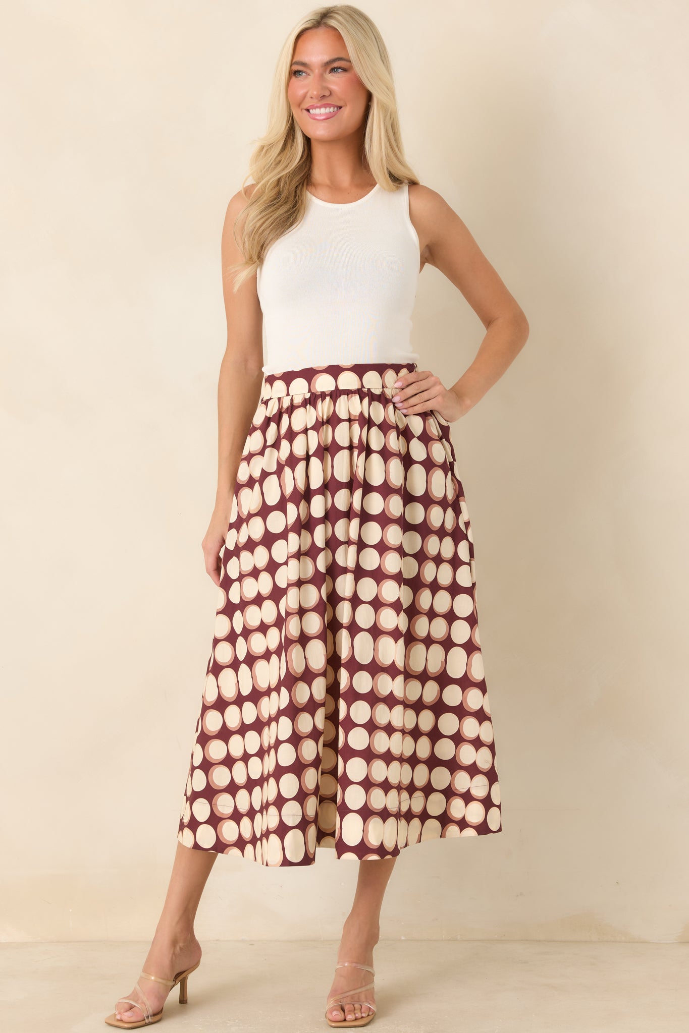 Full A-line cotton skirt with softly gathered fabric, a flat front waistband, comfortable elasticized back, and practical side pockets.