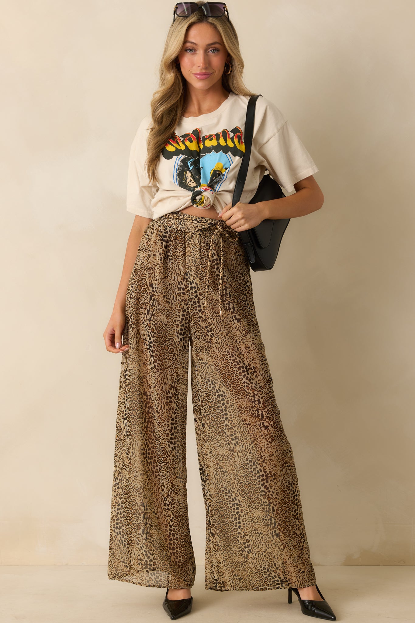 A full front view of the leopard print pants showing the wide leg silhouette and high-rise waist.