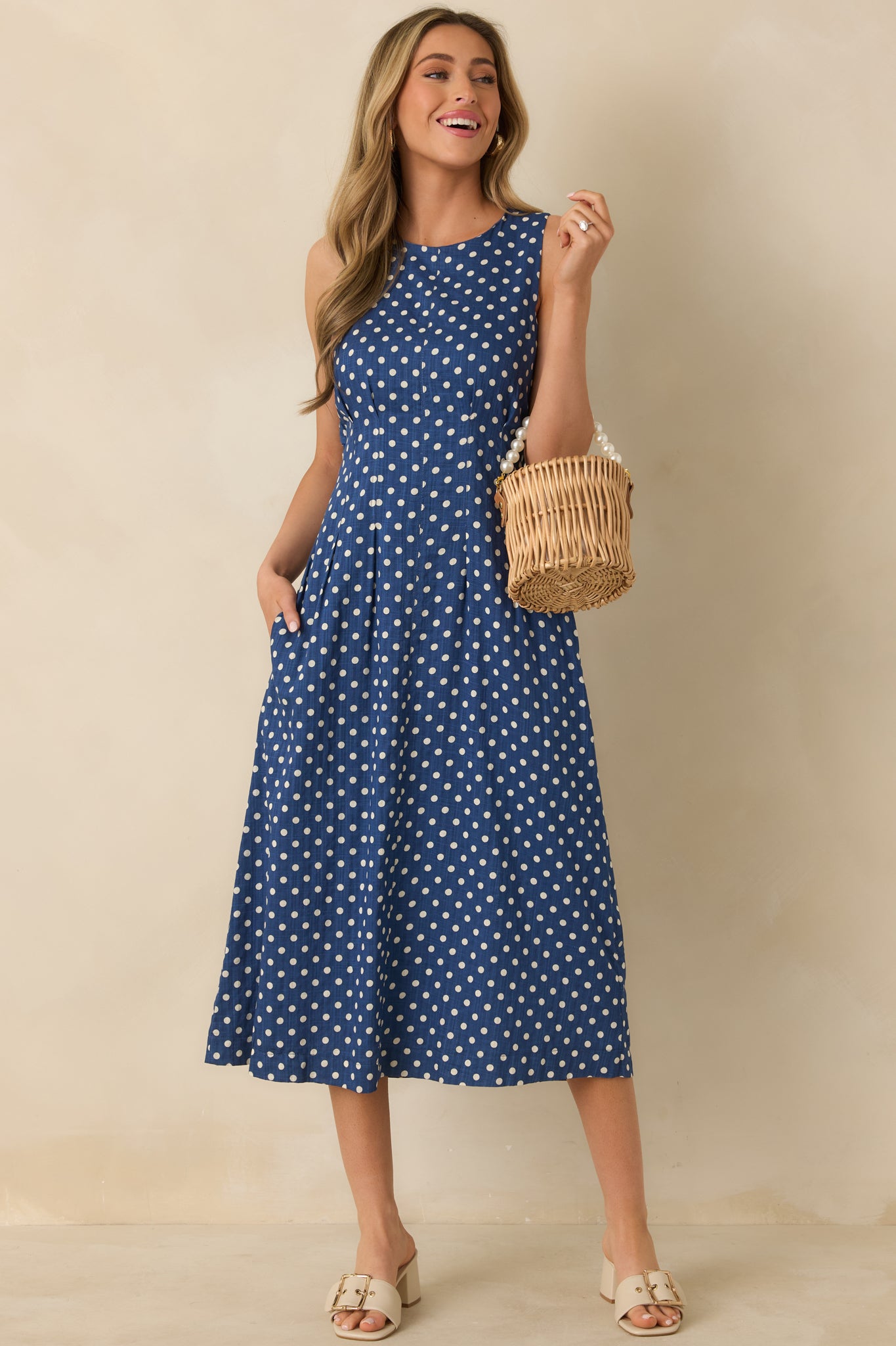 Full front-facing image emphasizing sleeveless design and side seam pockets.