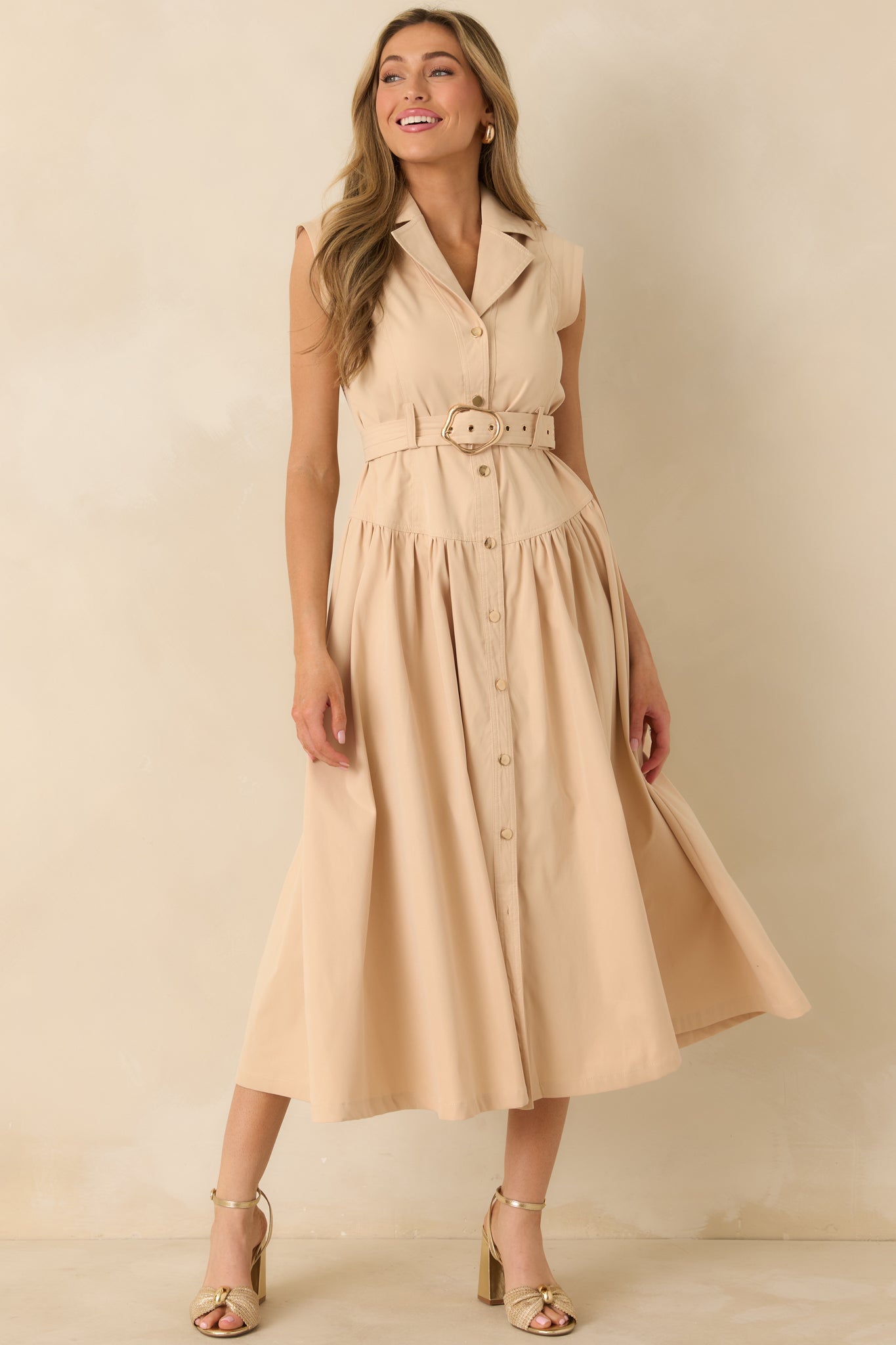 Full body front view of the beige midi shirt dress featuring a sleeveless design, structured collar, and button-front closure.