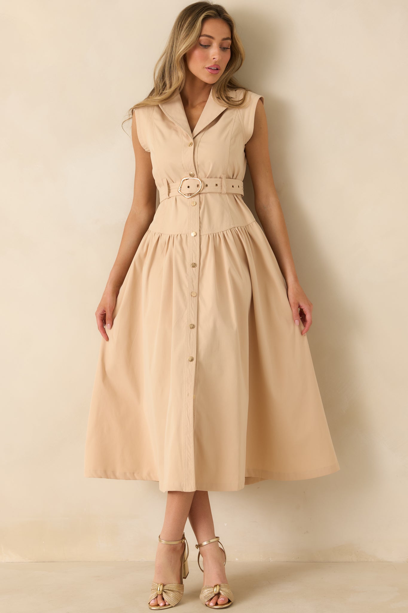 Full length front view focusing on the classic collar and streamlined midi-length shape.