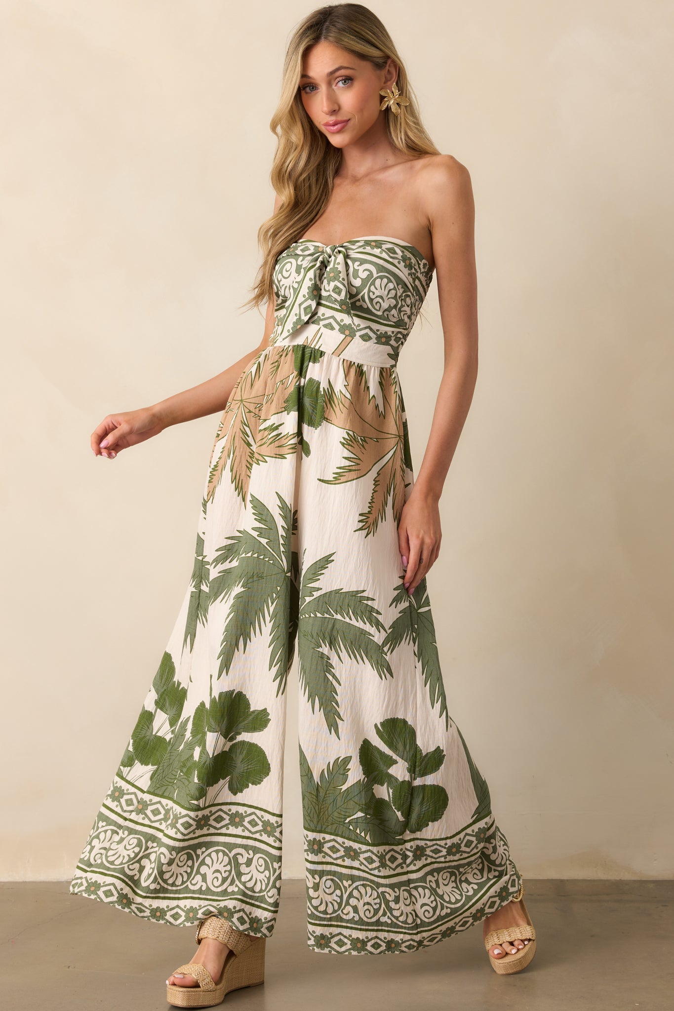 Full body image emphasizing the length and vertical flow of the pant legs with tropical print accents.