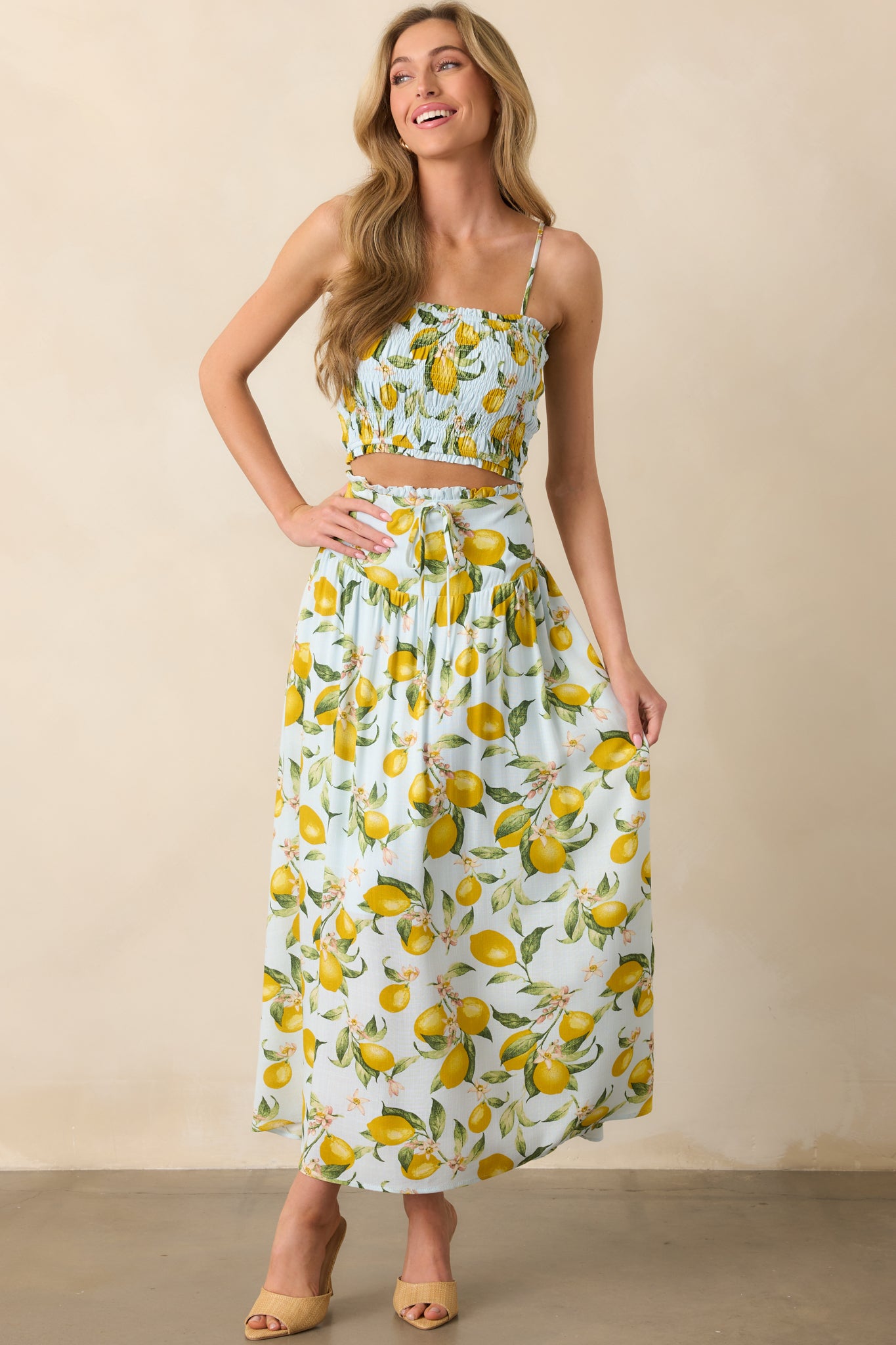Front-facing full length image of lemon-printed skirt highlighting the self-tie bow detail and relaxed silhouette.