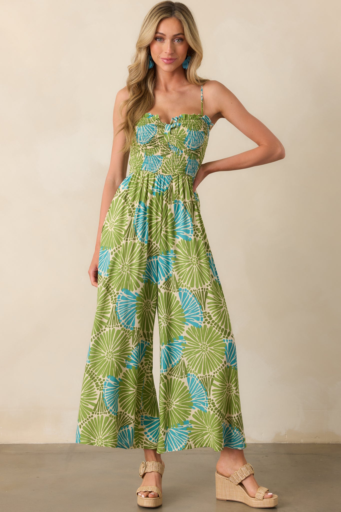 Head-to-toe image highlighting the fully smocked bust and lightweight rayon-linen fabric of the floral jumpsuit.