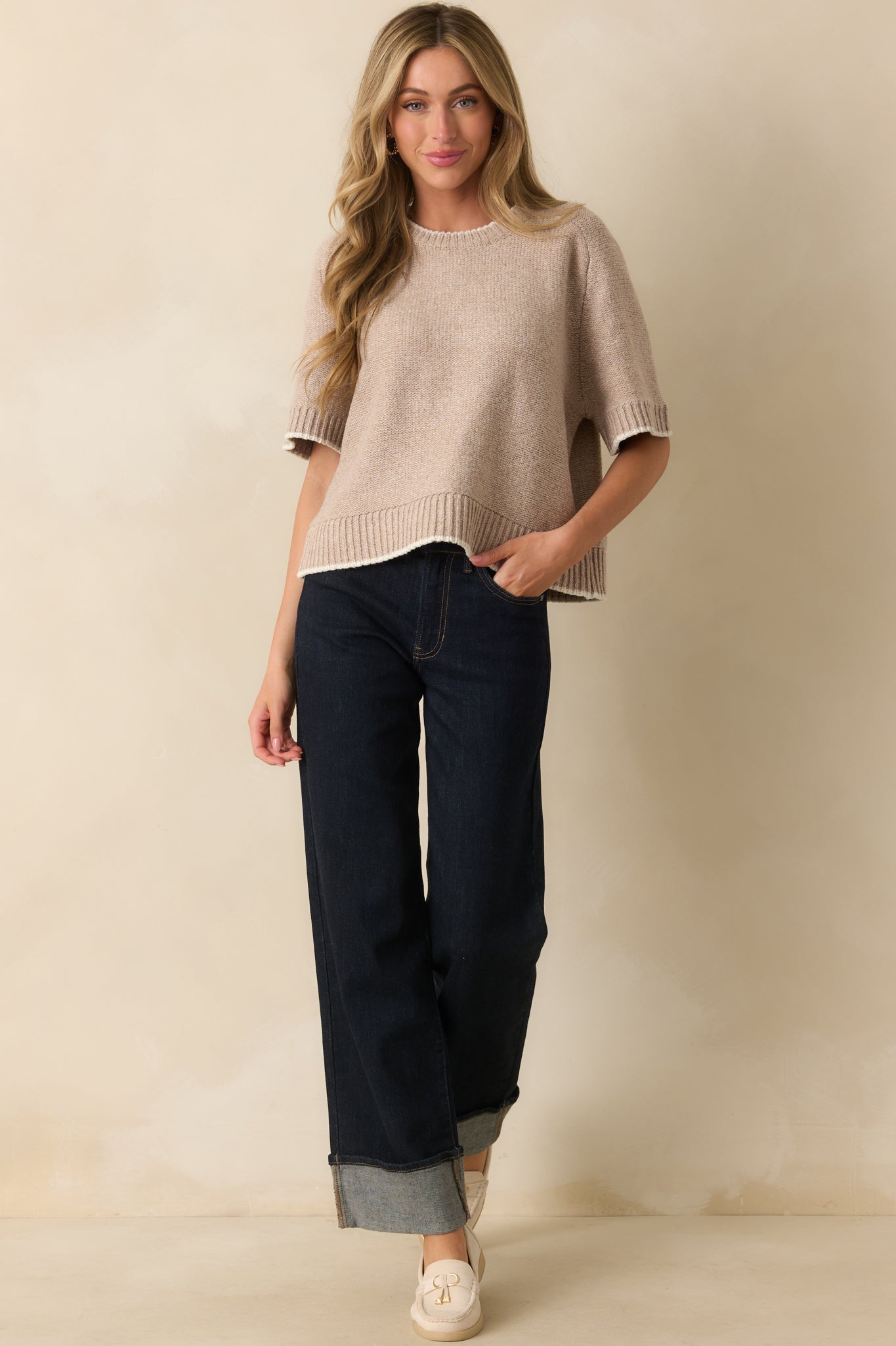 Full-length front view showing ivory contrast trim and short sleeves on beige sweater.