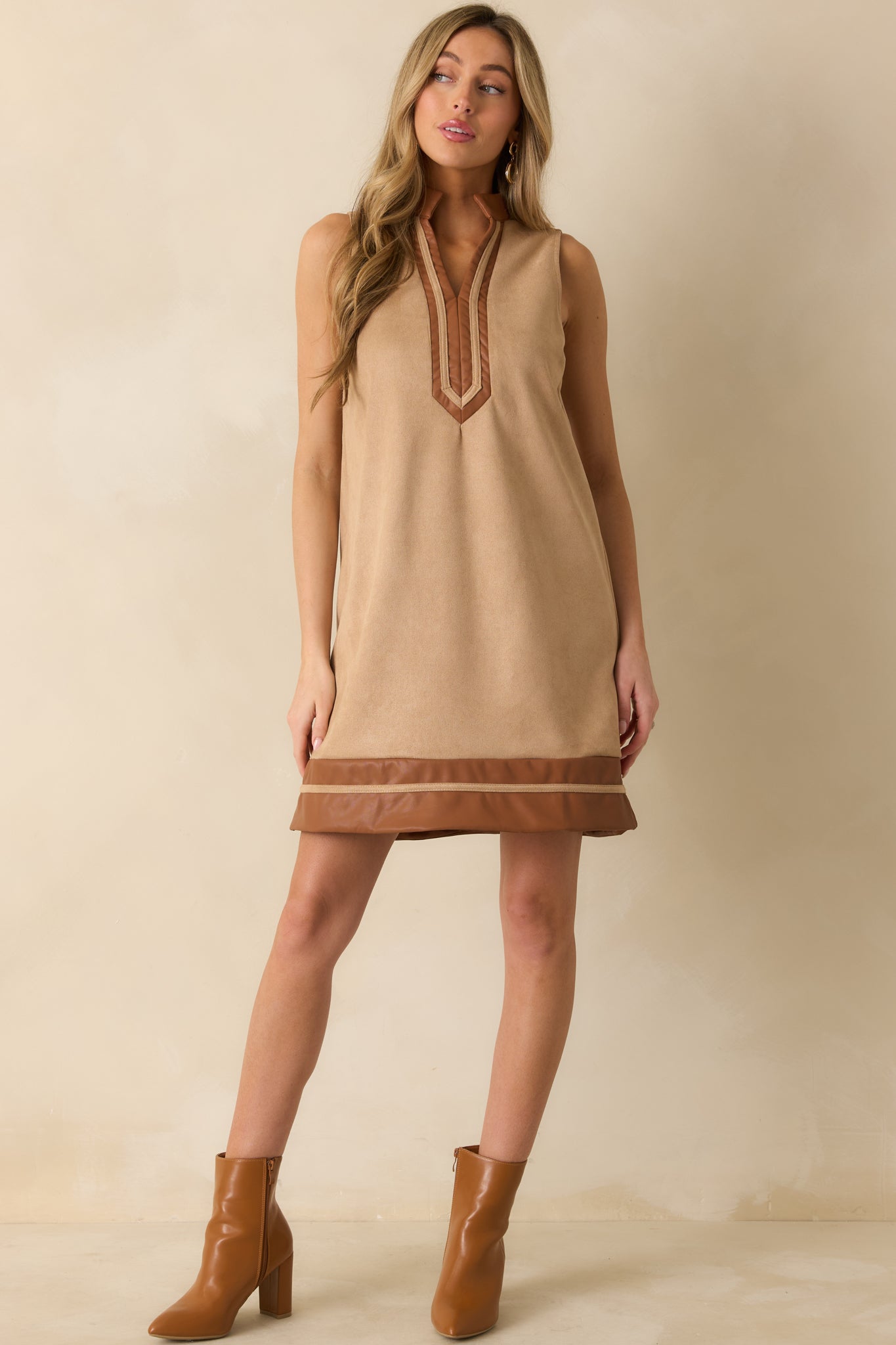 Full-length front view of tan mini dress showing straight silhouette and subtle texture of faux suede.