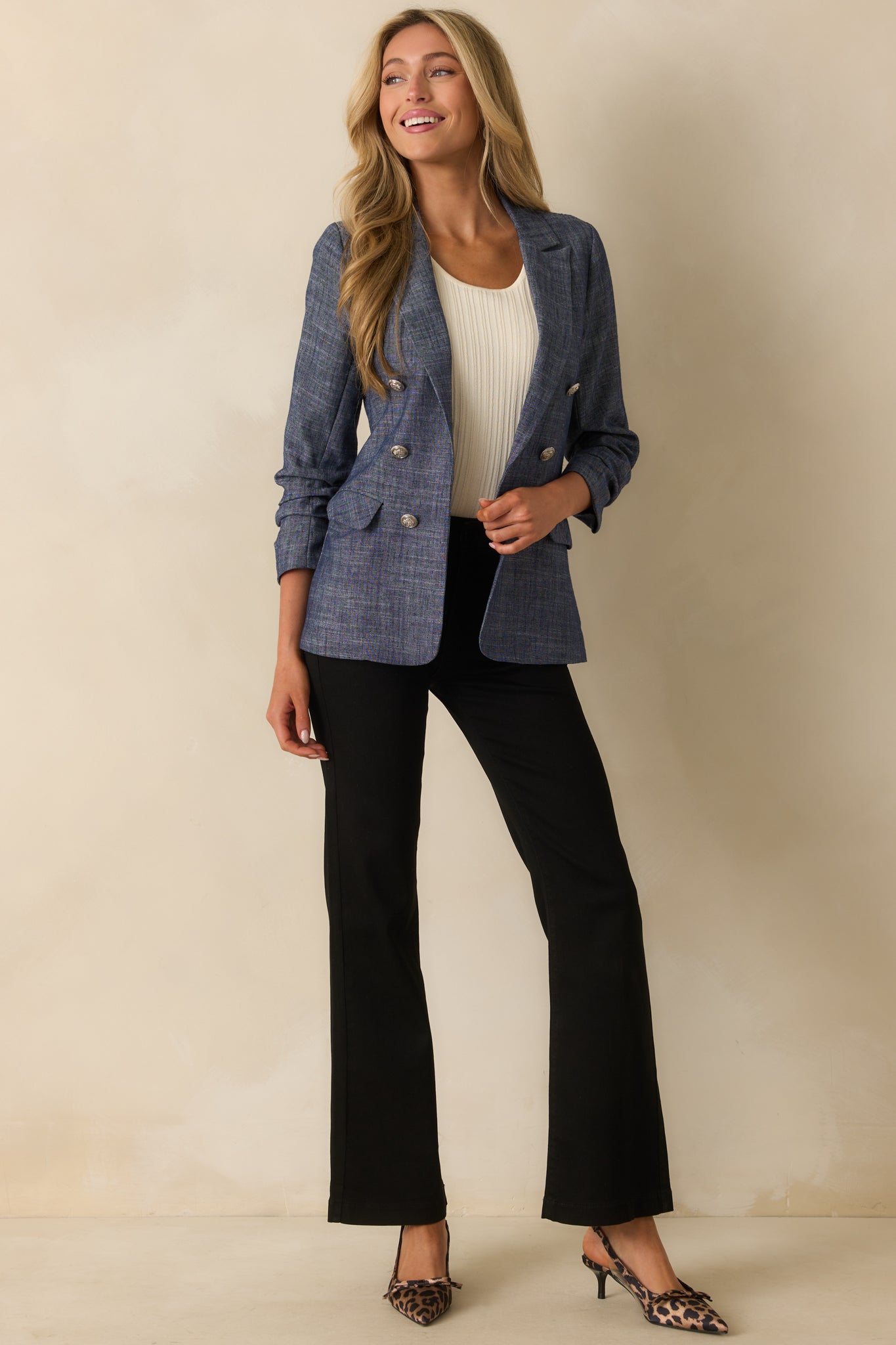A full-length view showing the blazer’s functional hip pockets and relaxed fit.