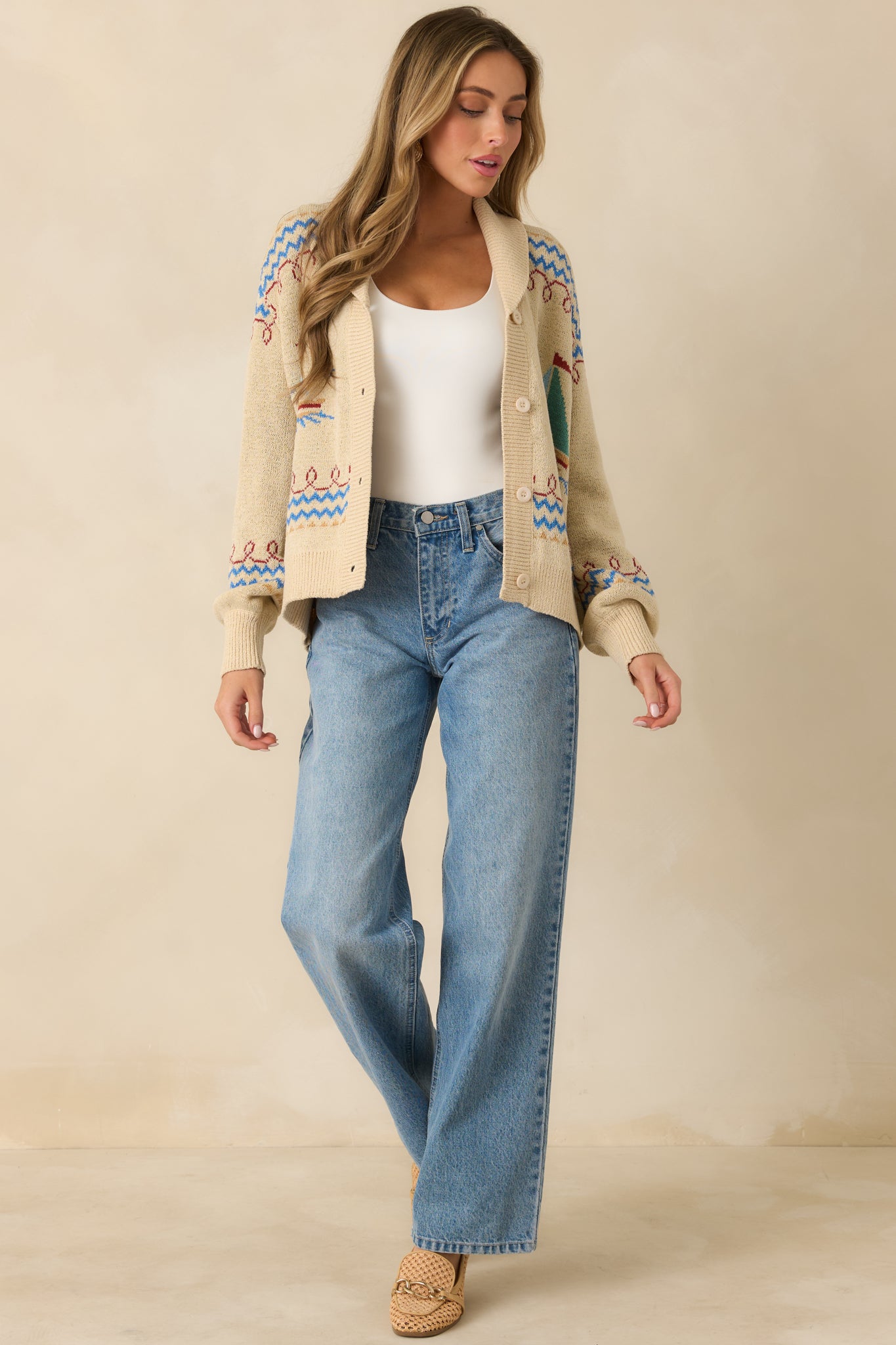 Full-length front view emphasizing the long sleeves, button closure, and easy layering silhouette.