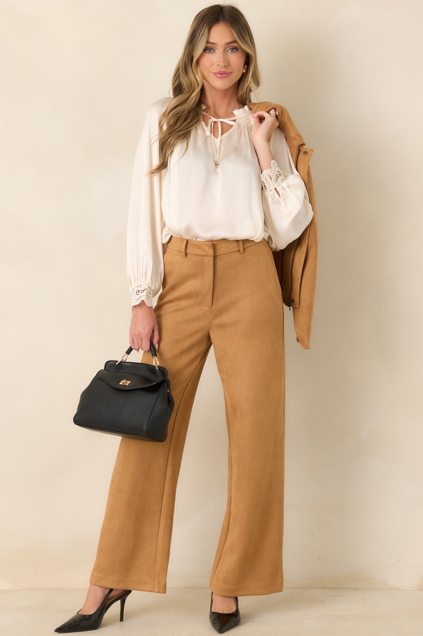 Full-length pants designed with a relaxed wide-leg fit, belt loops, side pockets, and a polished tailored finish.
