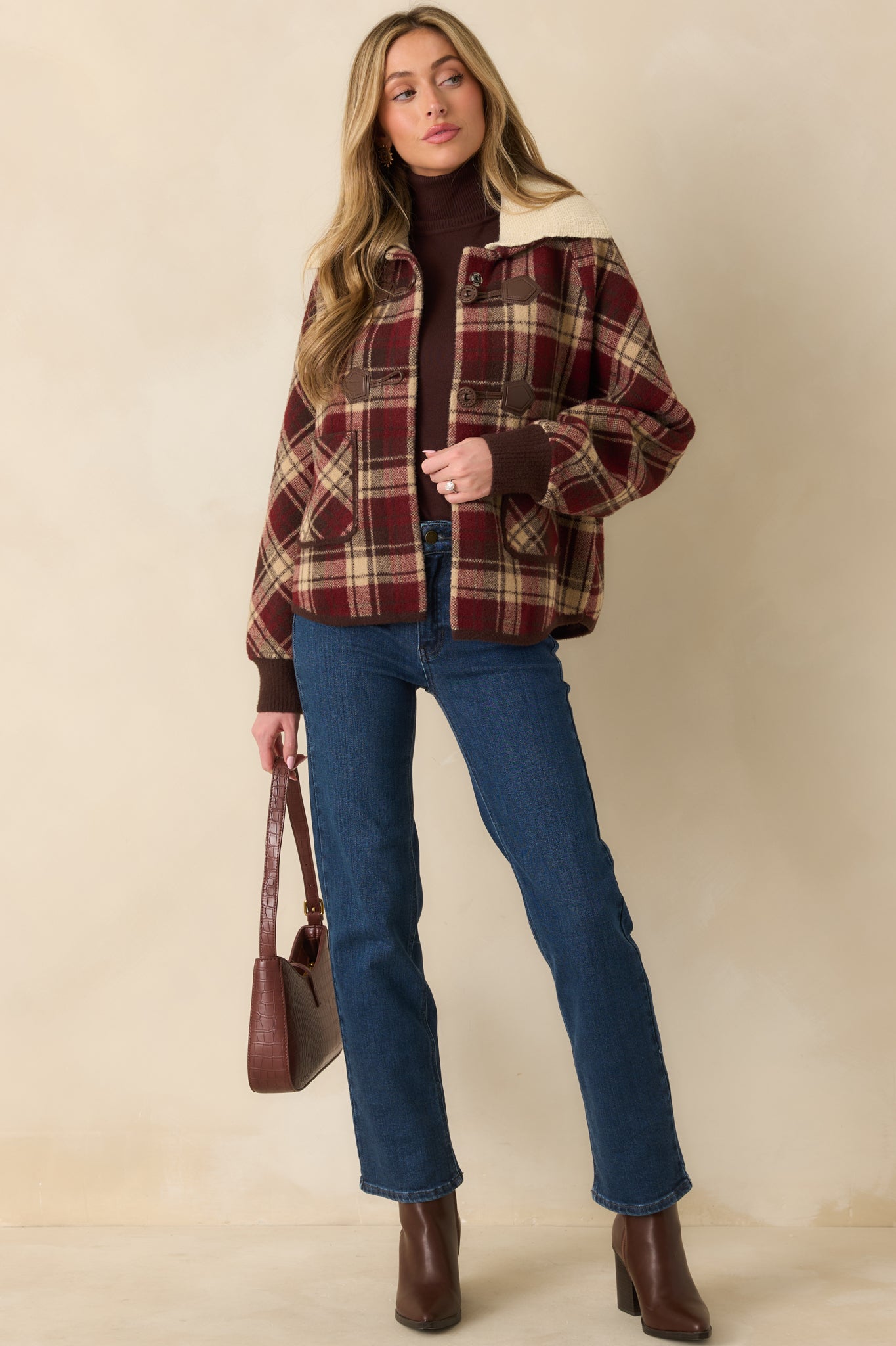 Full-length shot emphasizing relaxed silhouette, cozy knit collar, and button-front styling.
