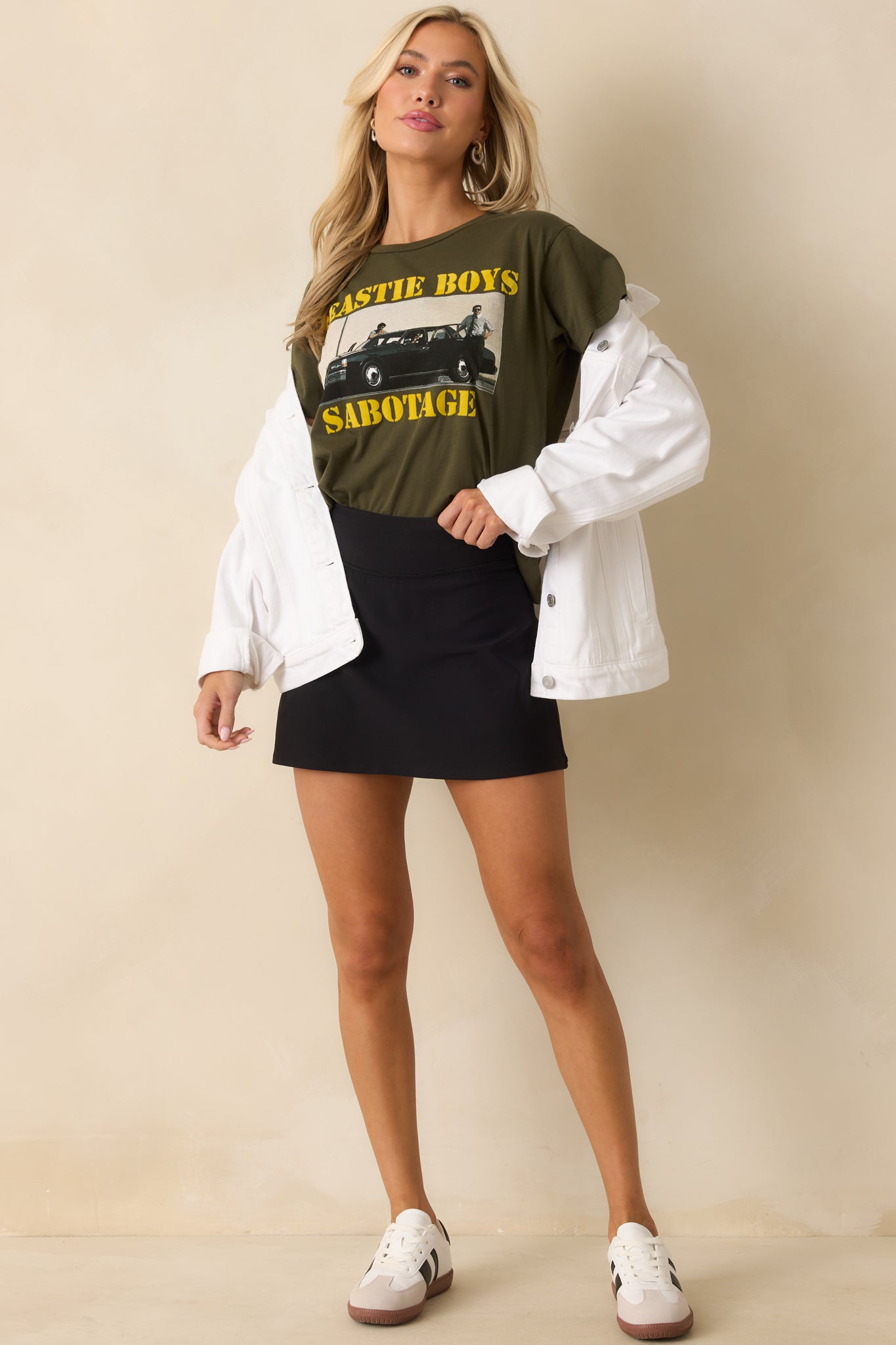 A full body shot highlighting the relaxed, boxy fit and short sleeves of the graphic tee.