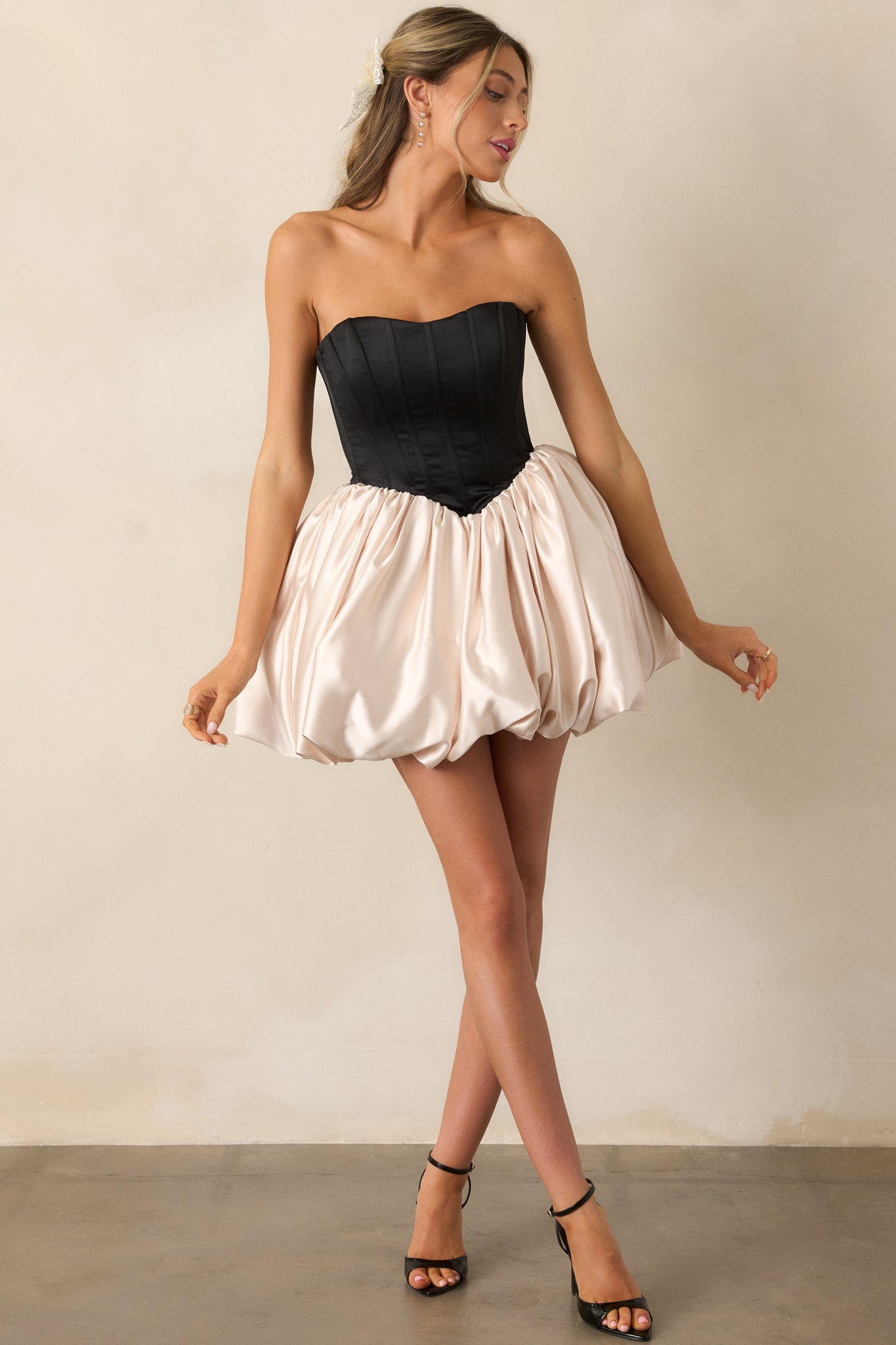 A full view of the black & ivory mini dress, showcasing its strapless corset top, basque waistline, and voluminous bubble skirt.