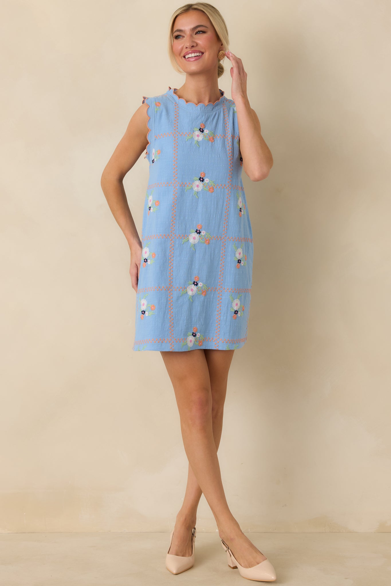 Full-length front view emphasizing the scalloped neckline, relaxed fit, and delicate embroidered floral design.