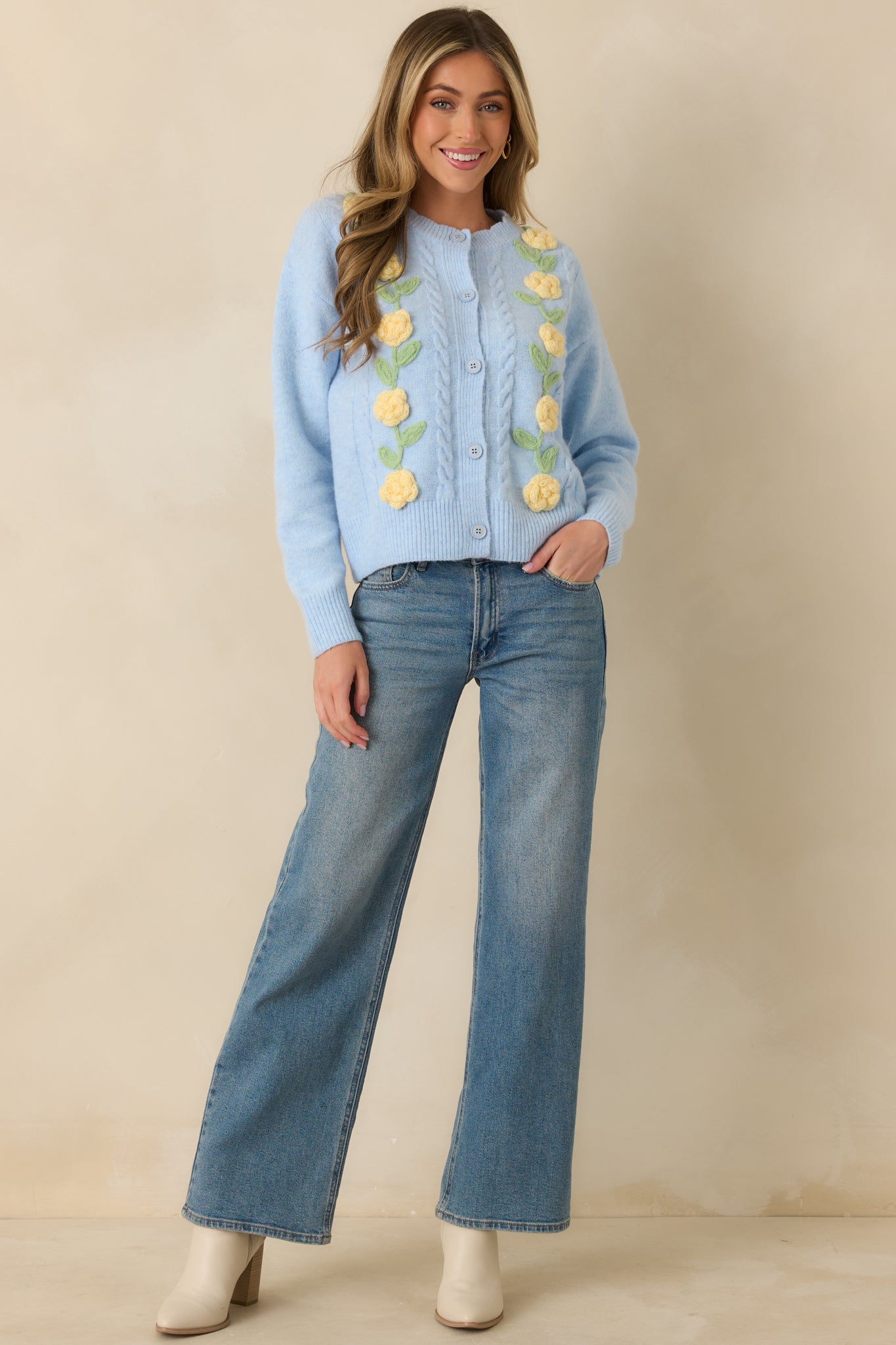 Full-length view highlighting raised floral appliqué along front panels and ribbed hem and cuffs.