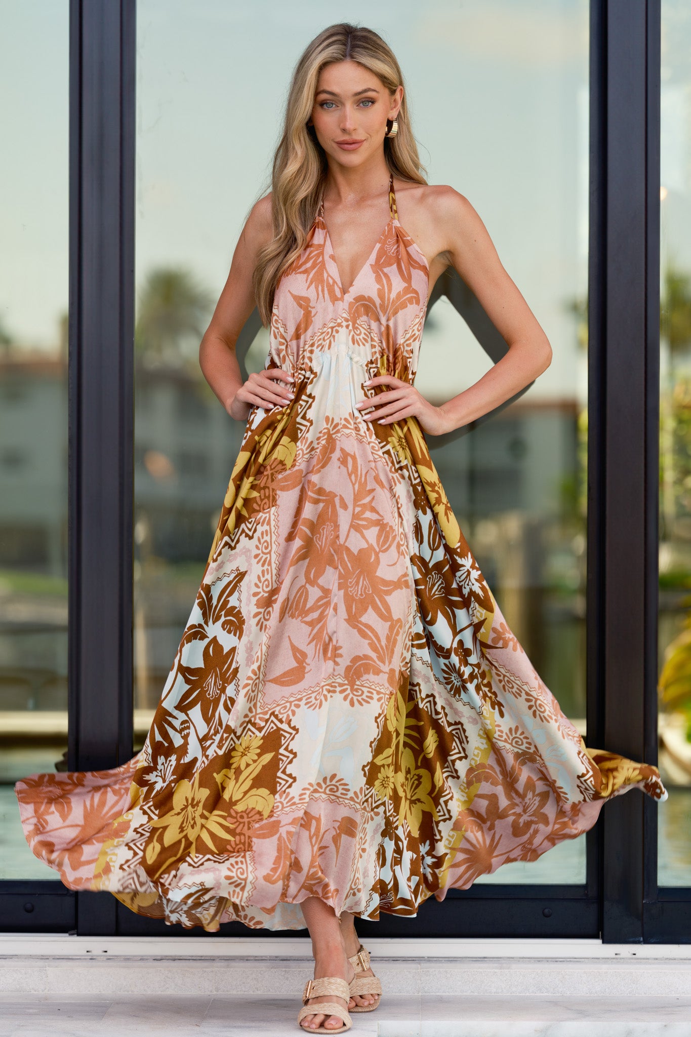 Full body view highlighting the flowy skirt and satin-like finish of the patchwork print maxi dress.