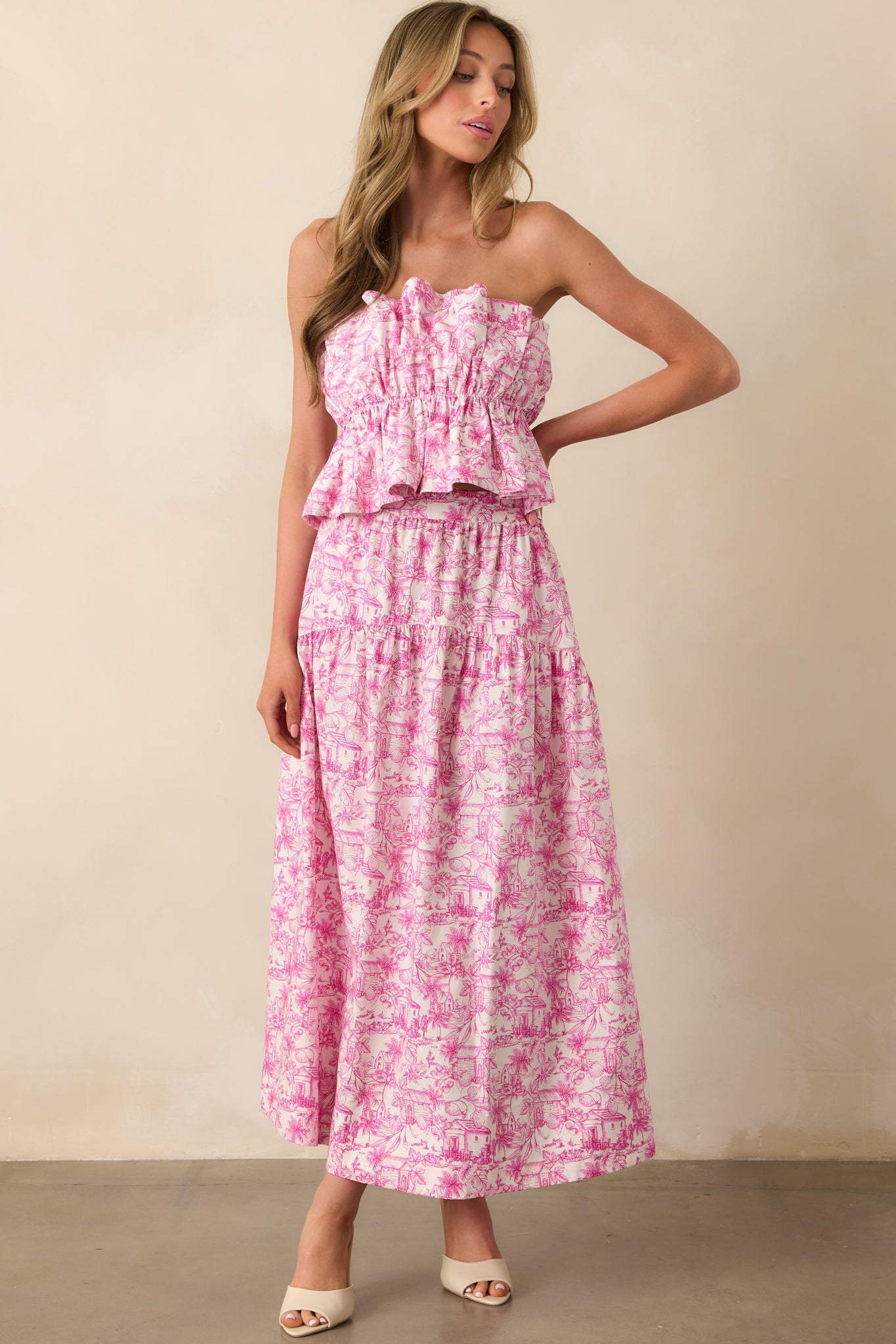 Front-facing full body view of a pink printed cotton crop top featuring a fitted elastic waist and flared hem.