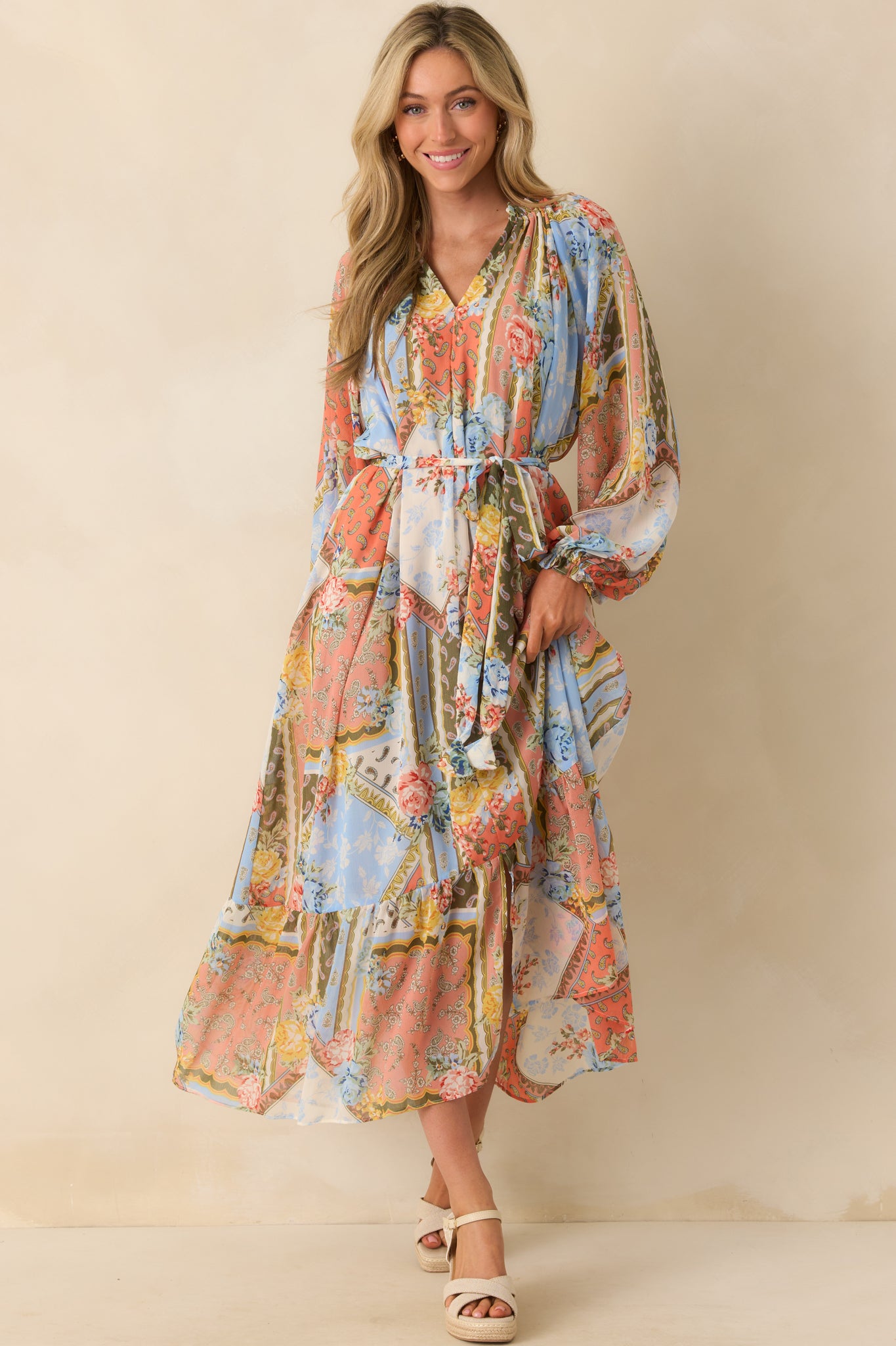 Full body front view of the multi floral print dress showcasing the ruffled collar and elastic cuffs.