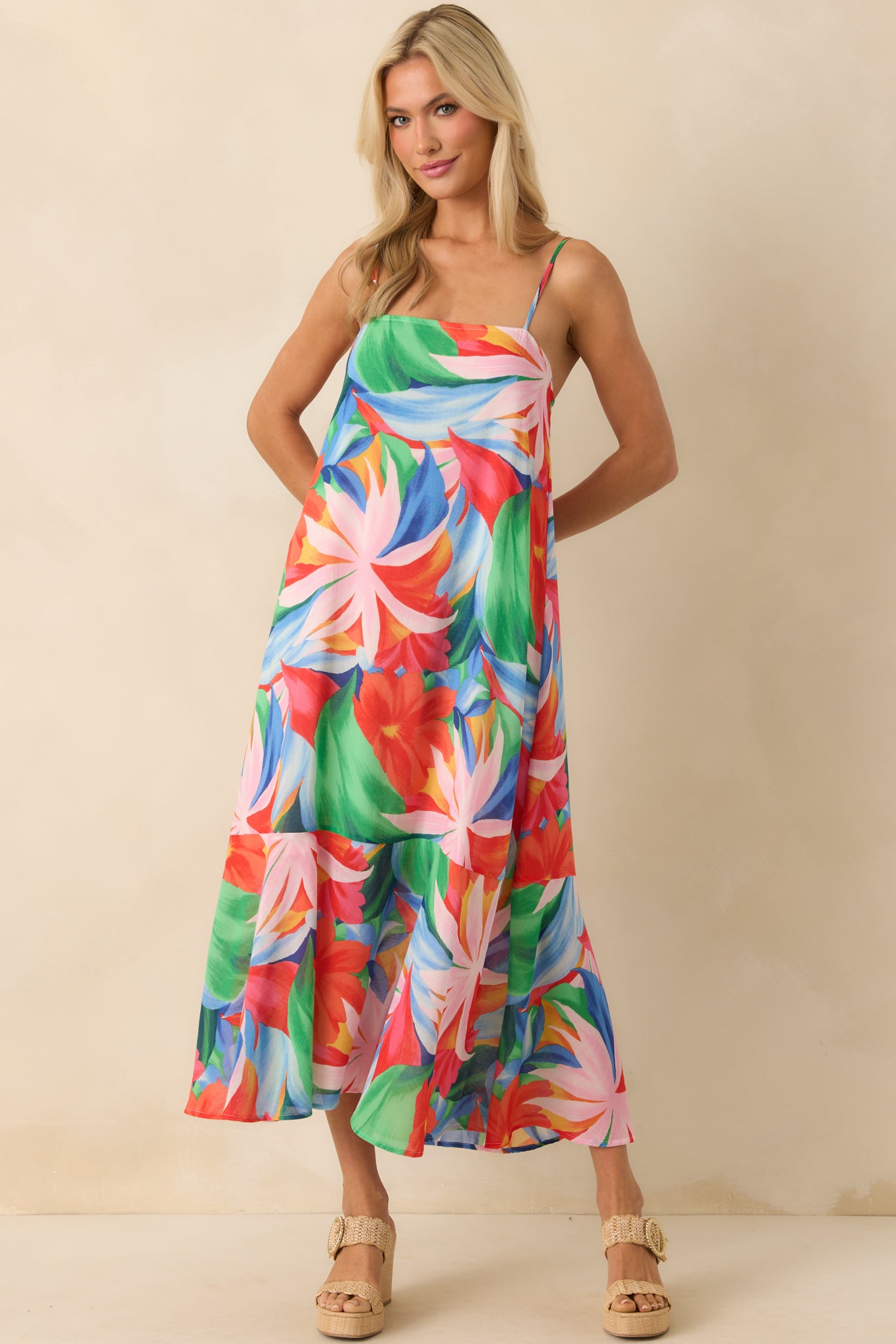 Full frontal view of the dress with a relaxed drape, emphasizing the interplay of tropical colors across the length of the fabric and the airy, floor-grazing silhouette.
