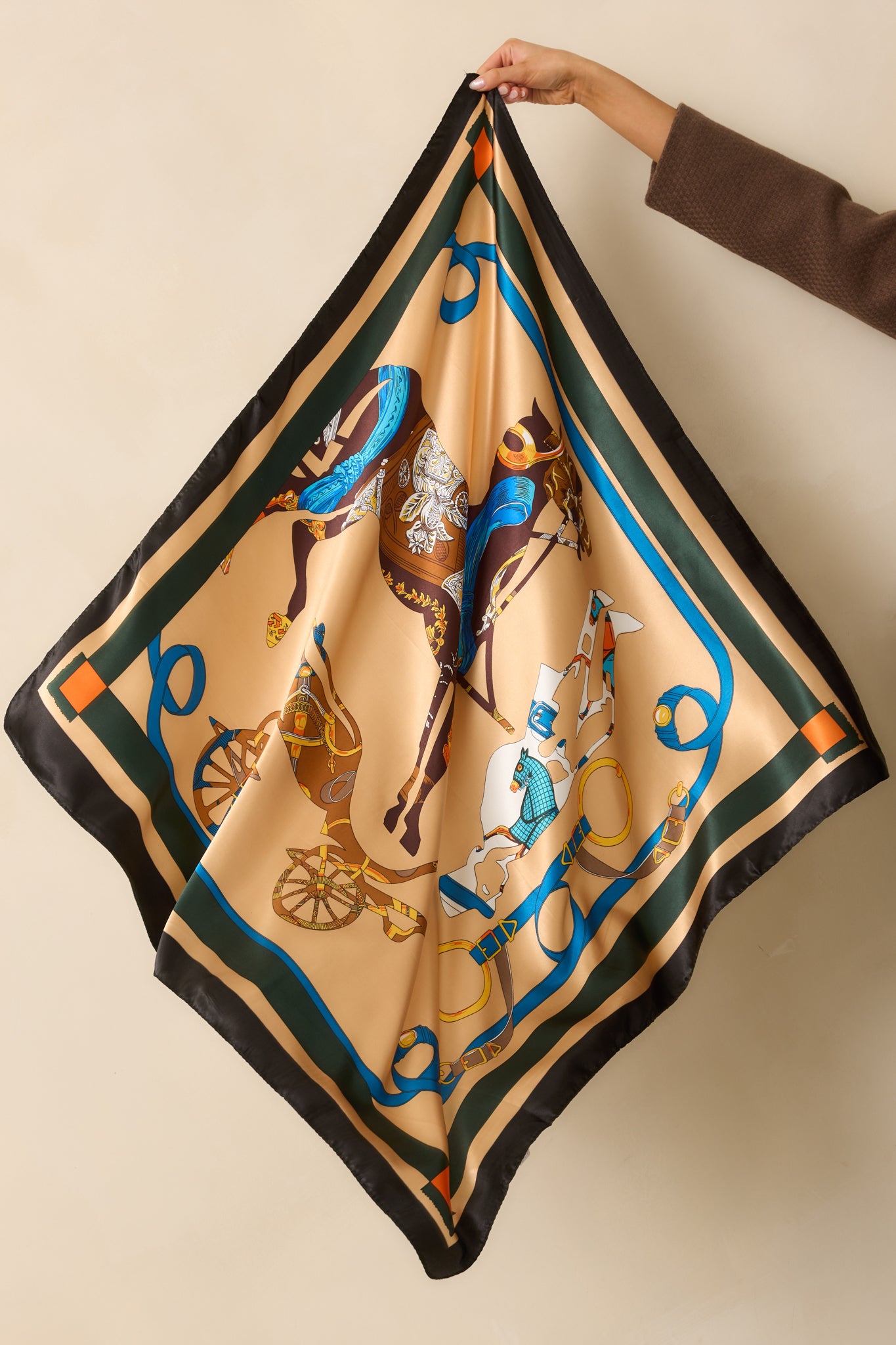A complete view of the scarf highlighting the striped border, satin finish, and equestrian horse print.