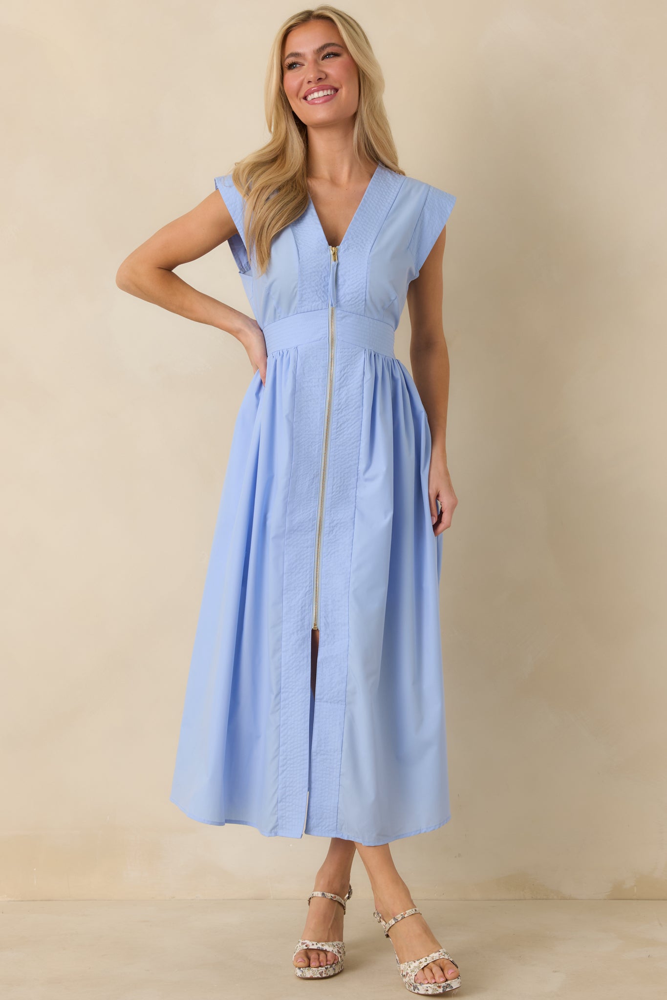 Full-length front view showcasing the fitted waist, lightly gathered skirt, and subtle sheen of the light blue fabric.