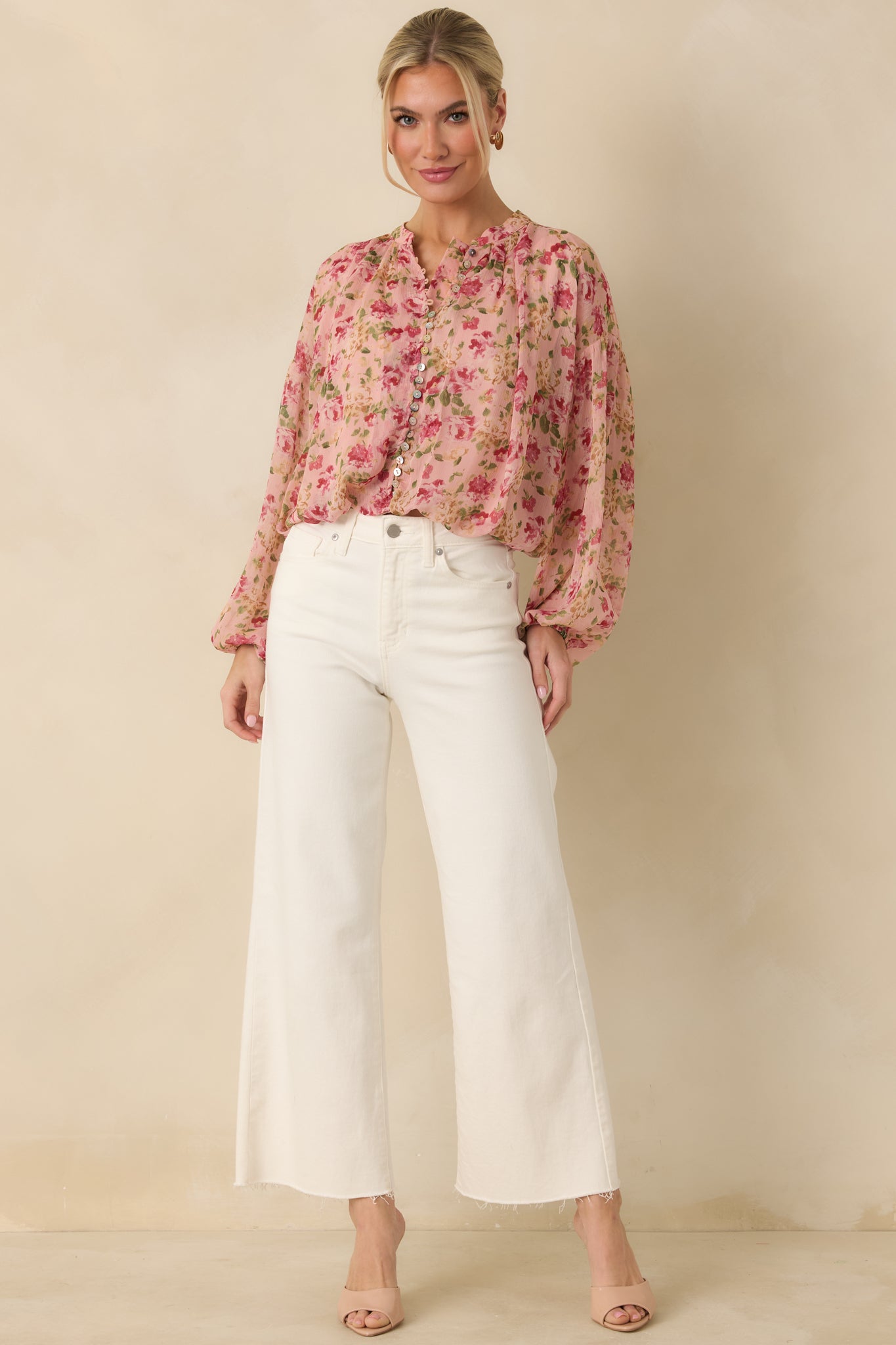Front-facing full-length view of the blush pink sheer blouse showing the button-front design and fully sheer long sleeves.