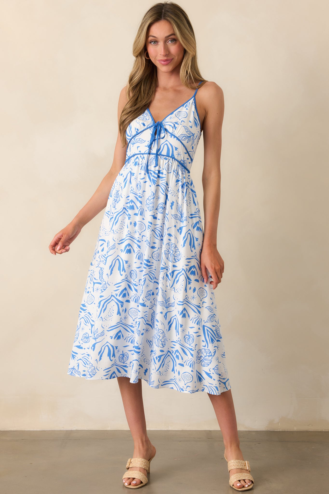 Full length image emphasizing the structured bustline with piping details and soft drape of the tropical fabric.