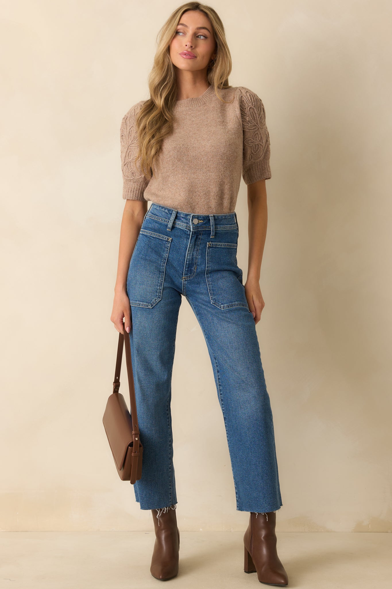 Full view of the sweater showing the relaxed fit, crew neckline, and subtle texture of the ribbed trim.