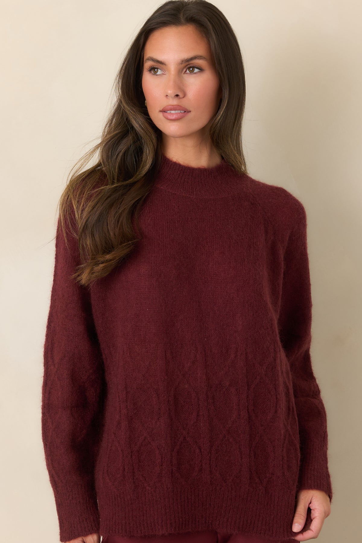 Fuzzy mohair-wool top featuring a ribbed mock neck and intricate textured cable-knit detailing.