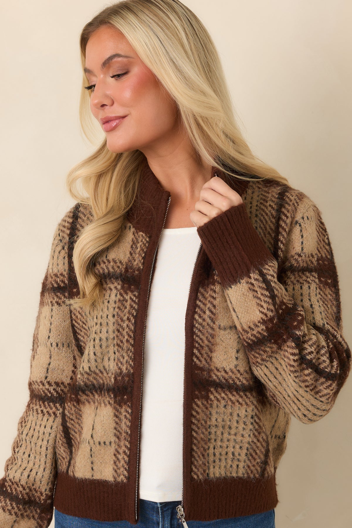 Fuzzy plaid cardigan with a relaxed silhouette and matching deep brown ribbed hem.
