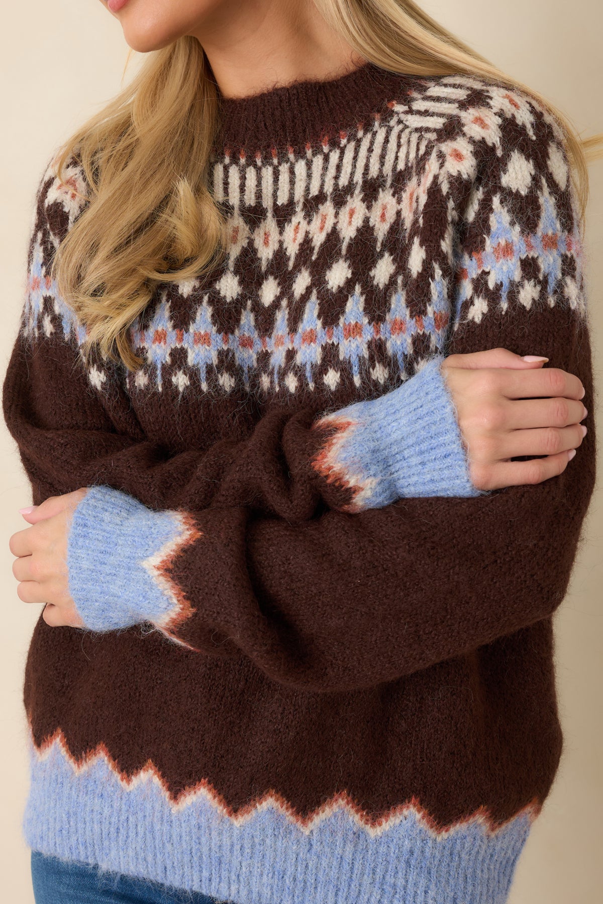 Close-up of the fuzzy wool-blend knit, Fair Isle pattern, and contrasting zigzag trim.