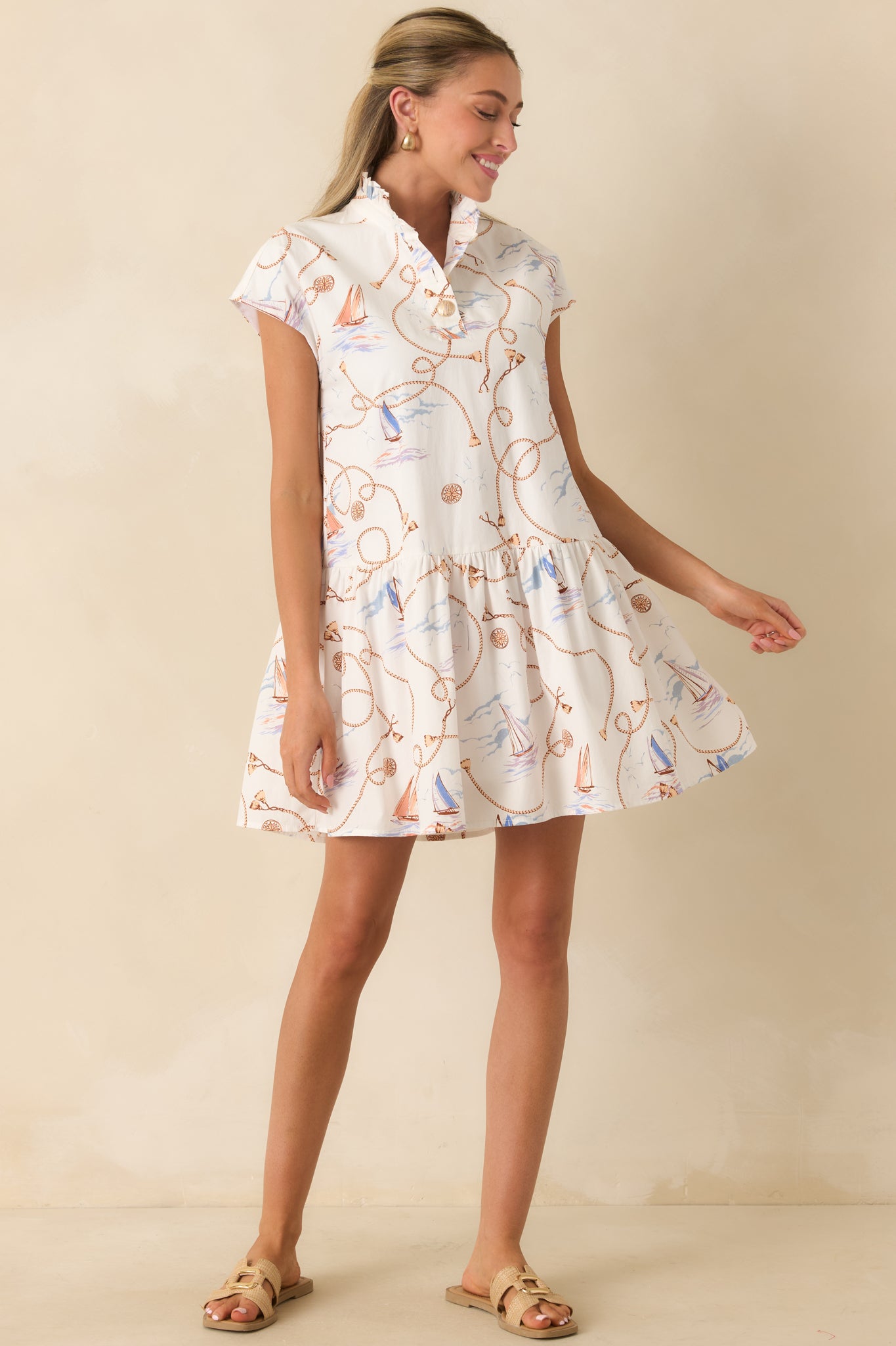 Easy-to-wear mini dress with a flouncy gathered skirt, split neckline, and soft cap sleeve detailing.