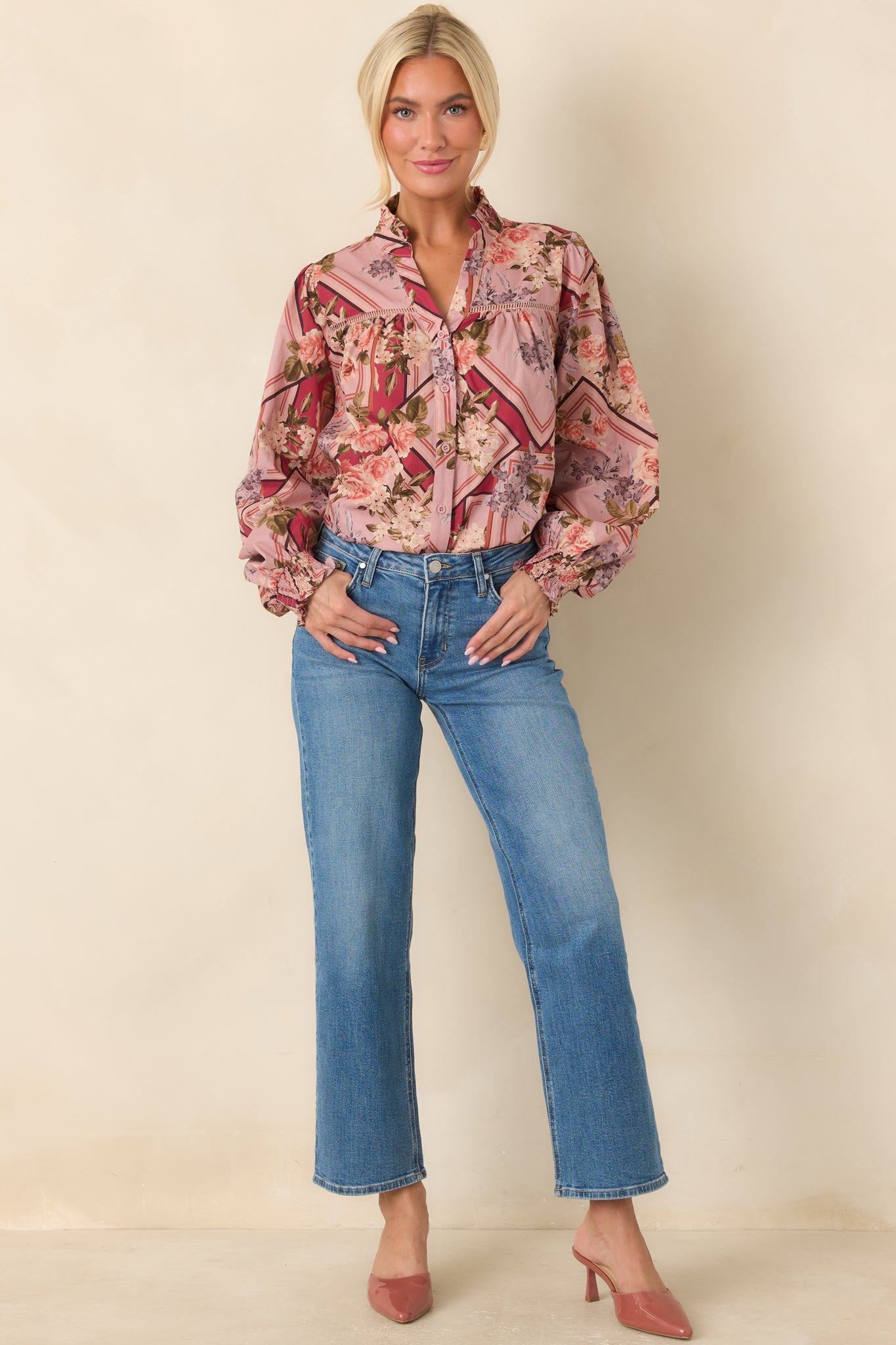 Cotton blouse showcasing a softly gathered yoke, ruffled stand neckline, full long sleeves, and elasticized smocked cuffs.