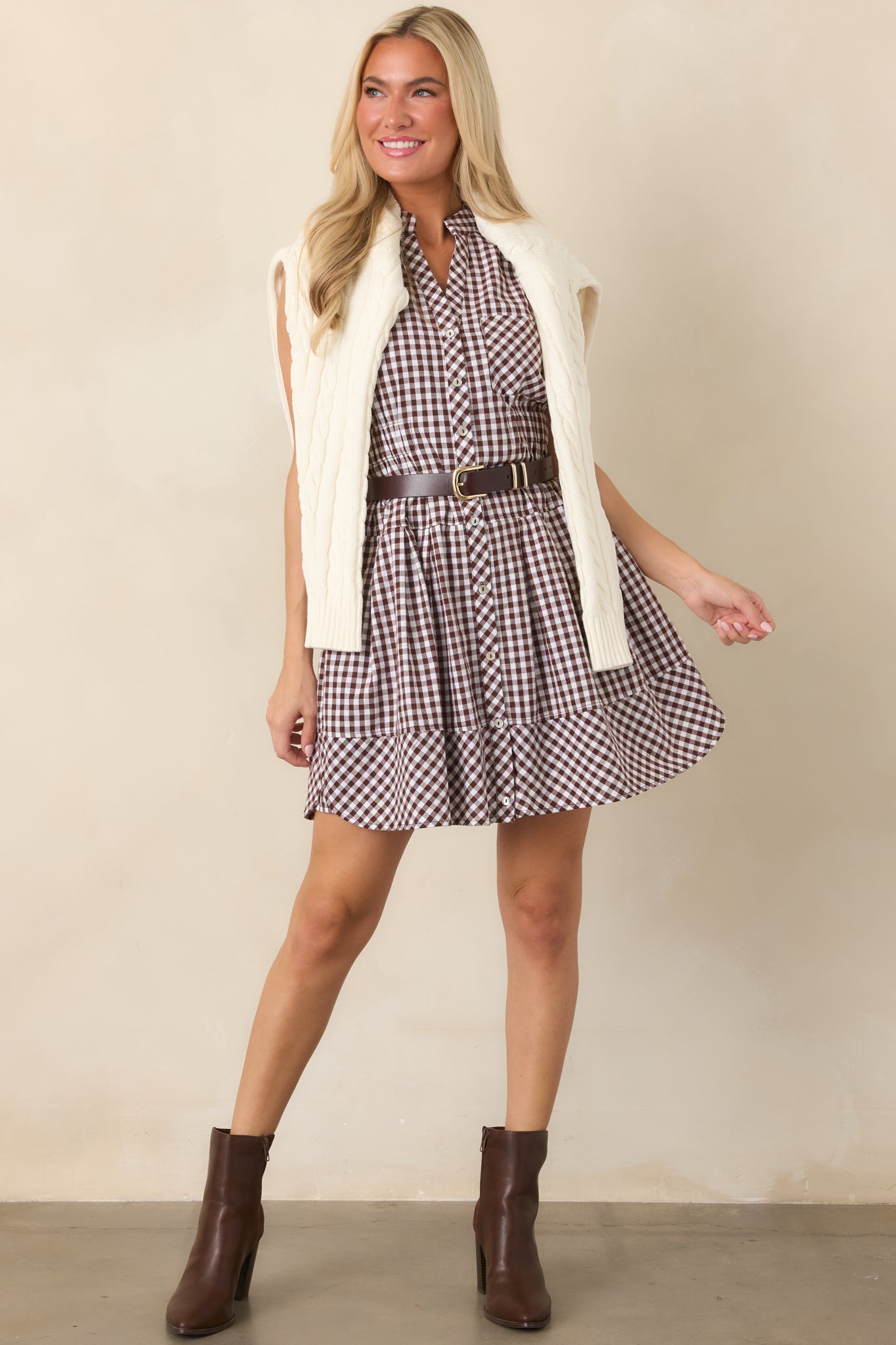 Gingham mini dress showcasing a tailored collar, chest pocket, covered button placket, and softly gathered elastic waistband.