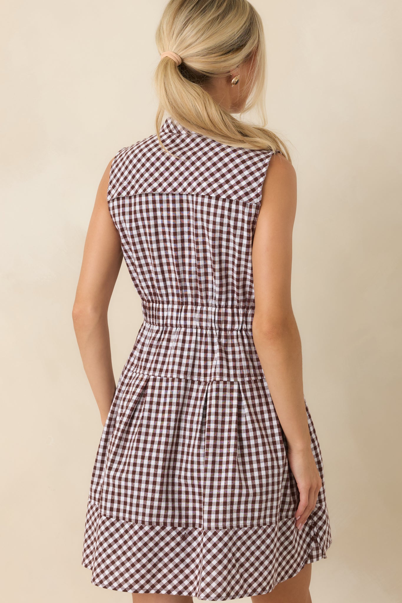 Rear view of the gingham mini dress featuring a relaxed silhouette, elastic waistband, and fully lined construction.