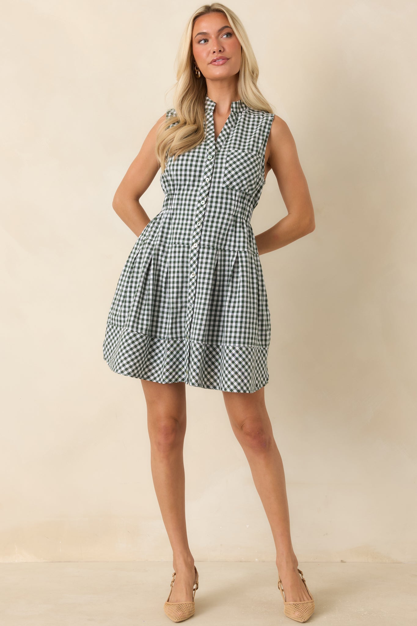 Gingham mini dress designed with a relaxed fit, functional chest pocket, hidden side pockets, and a flattering elastic waist.