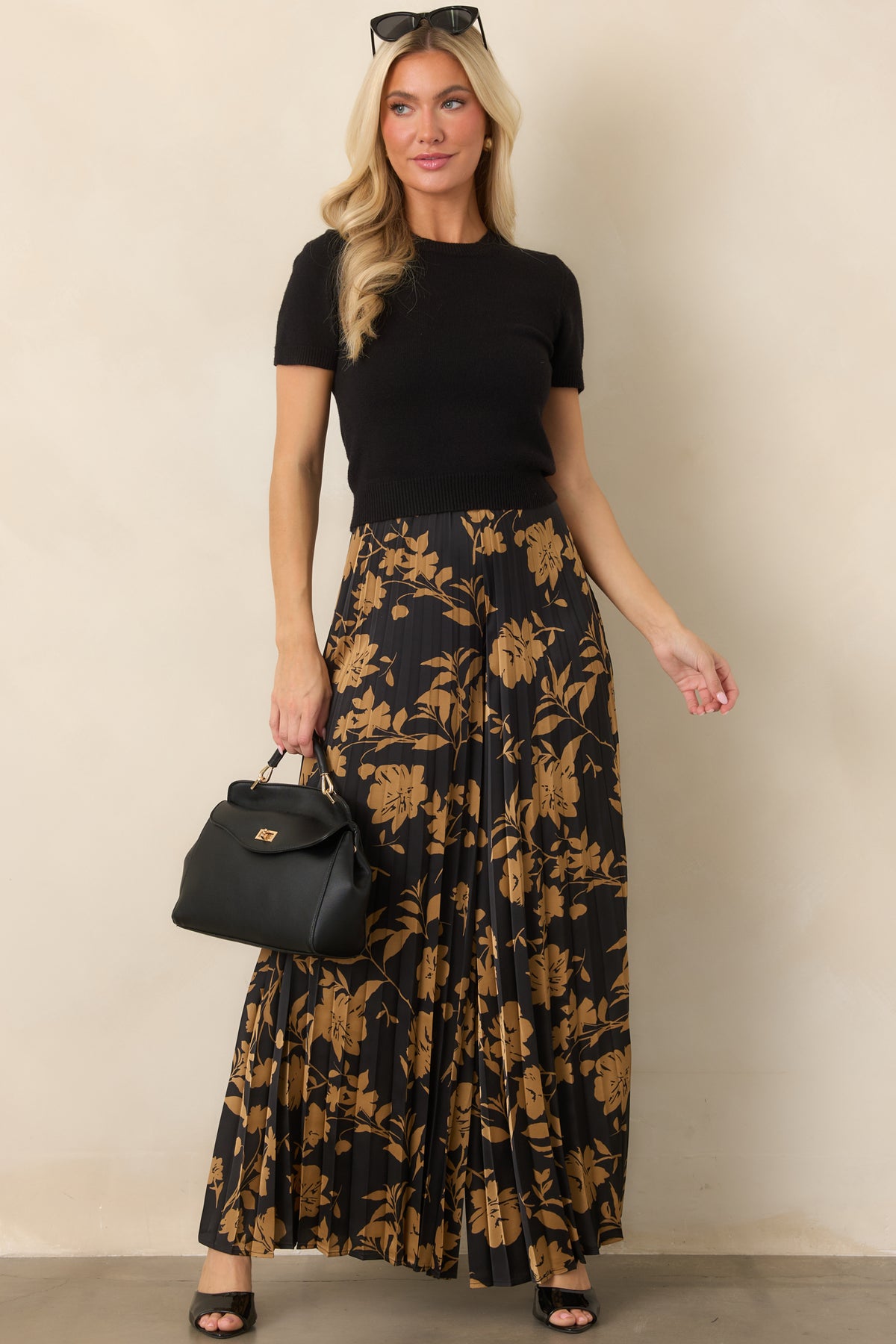 Golden floral print pants featuring sweeping accordion pleats and generously wide legs for a fluid silhouette.
