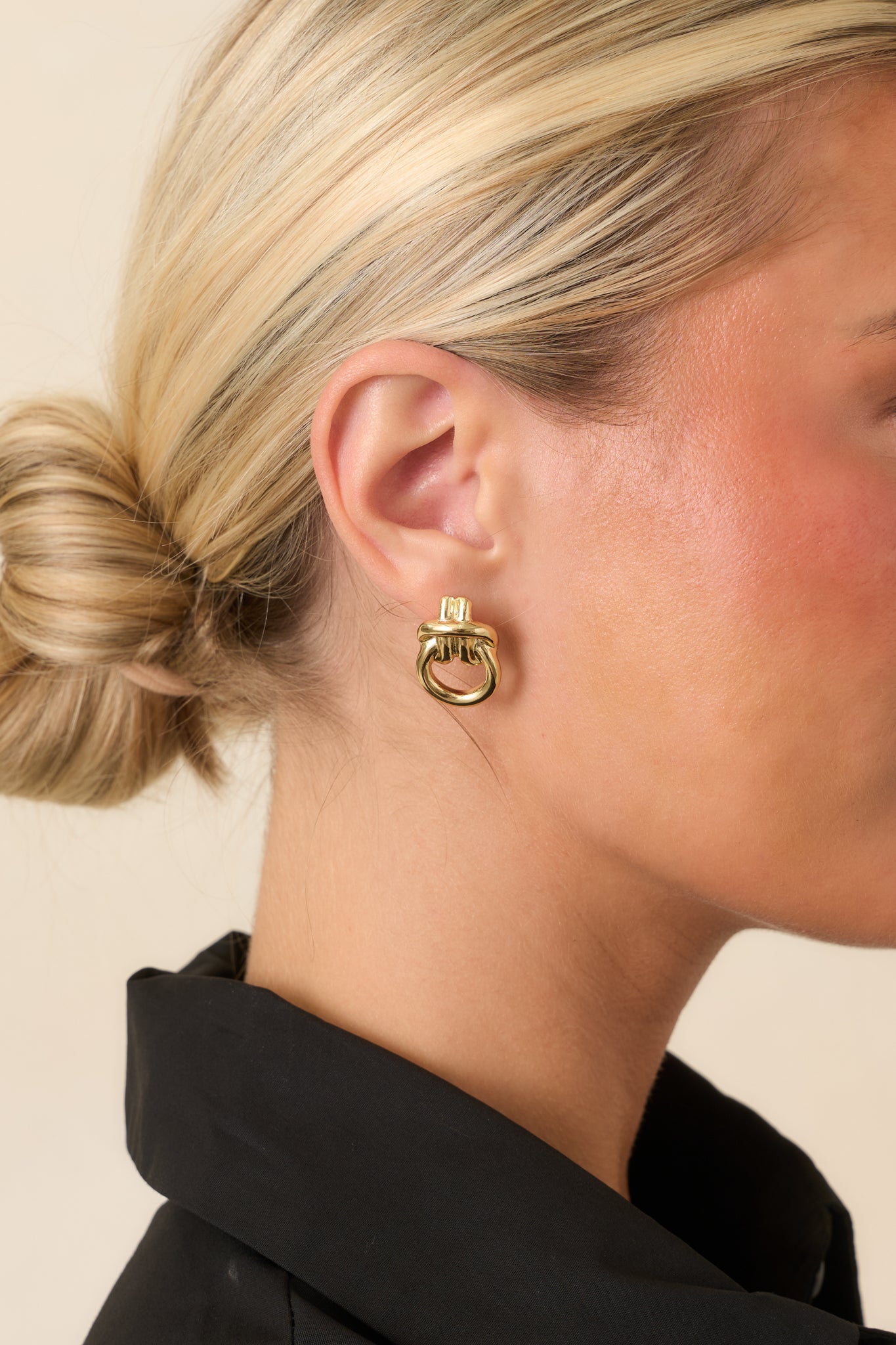 Gold sculptural stud earrings with a softly curved silhouette, lightweight design, and polished finish for an effortlessly modern look.